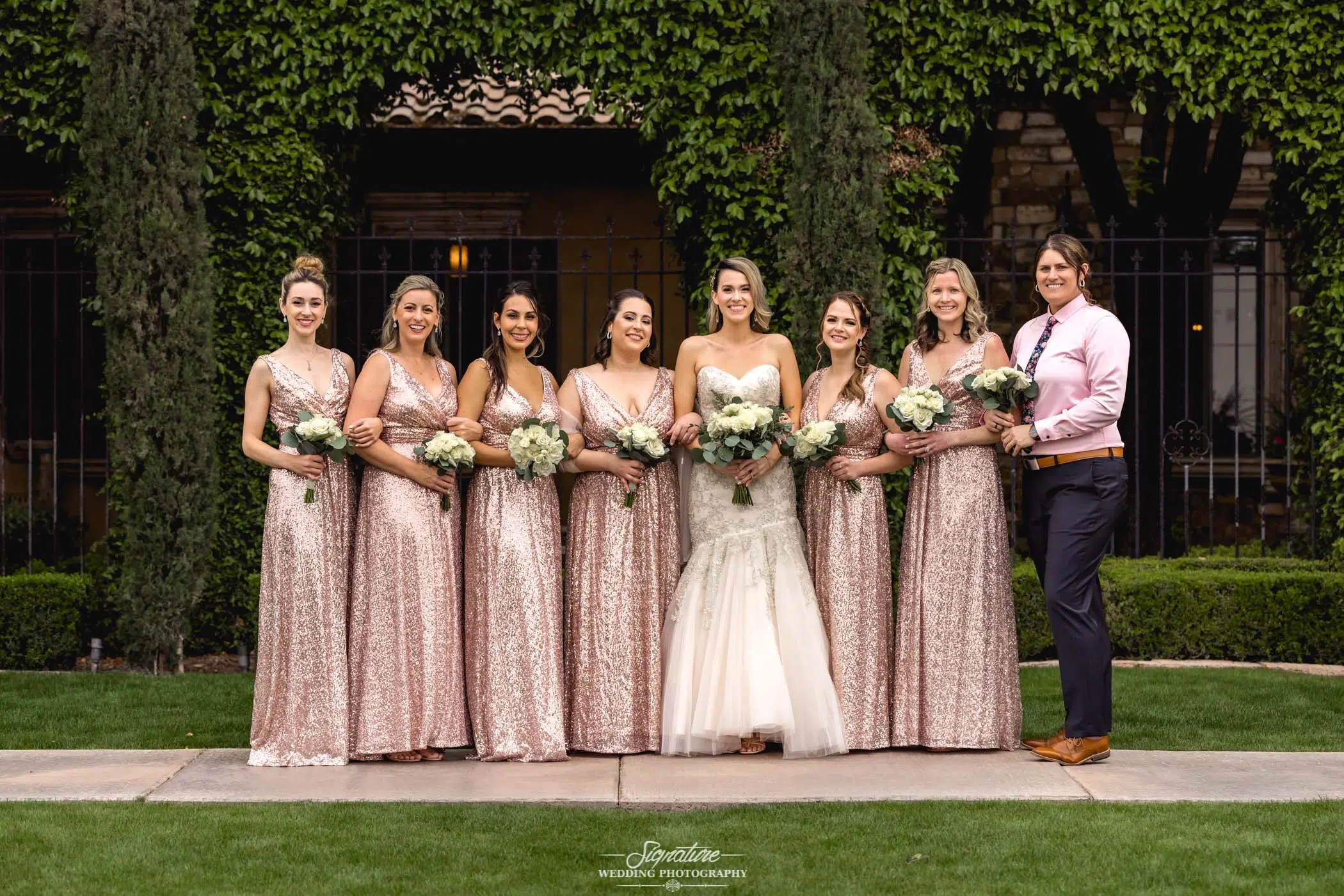 Bride and bridesmaids smiling at camera