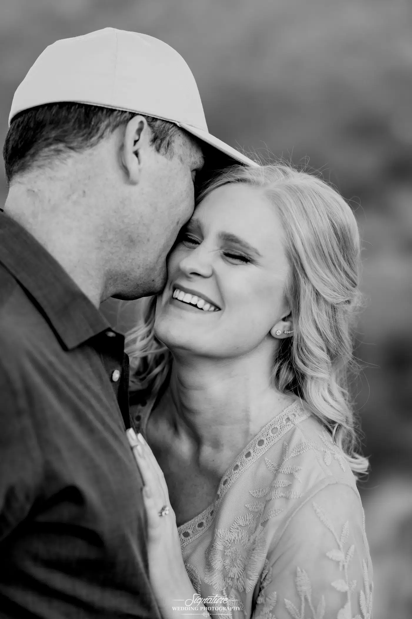 Man kissing woman's cheek black and white