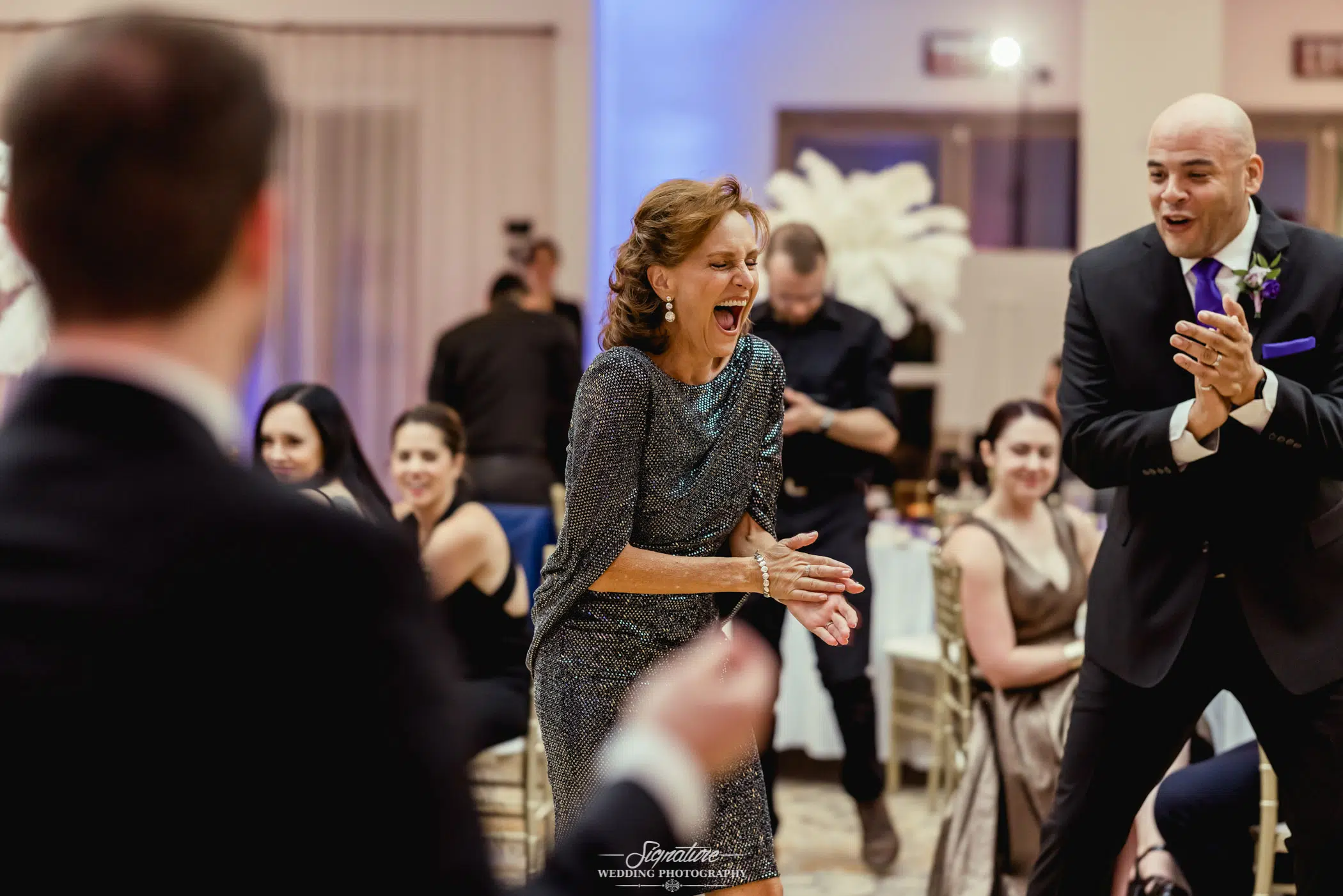 Wedding guests laughing and dancing