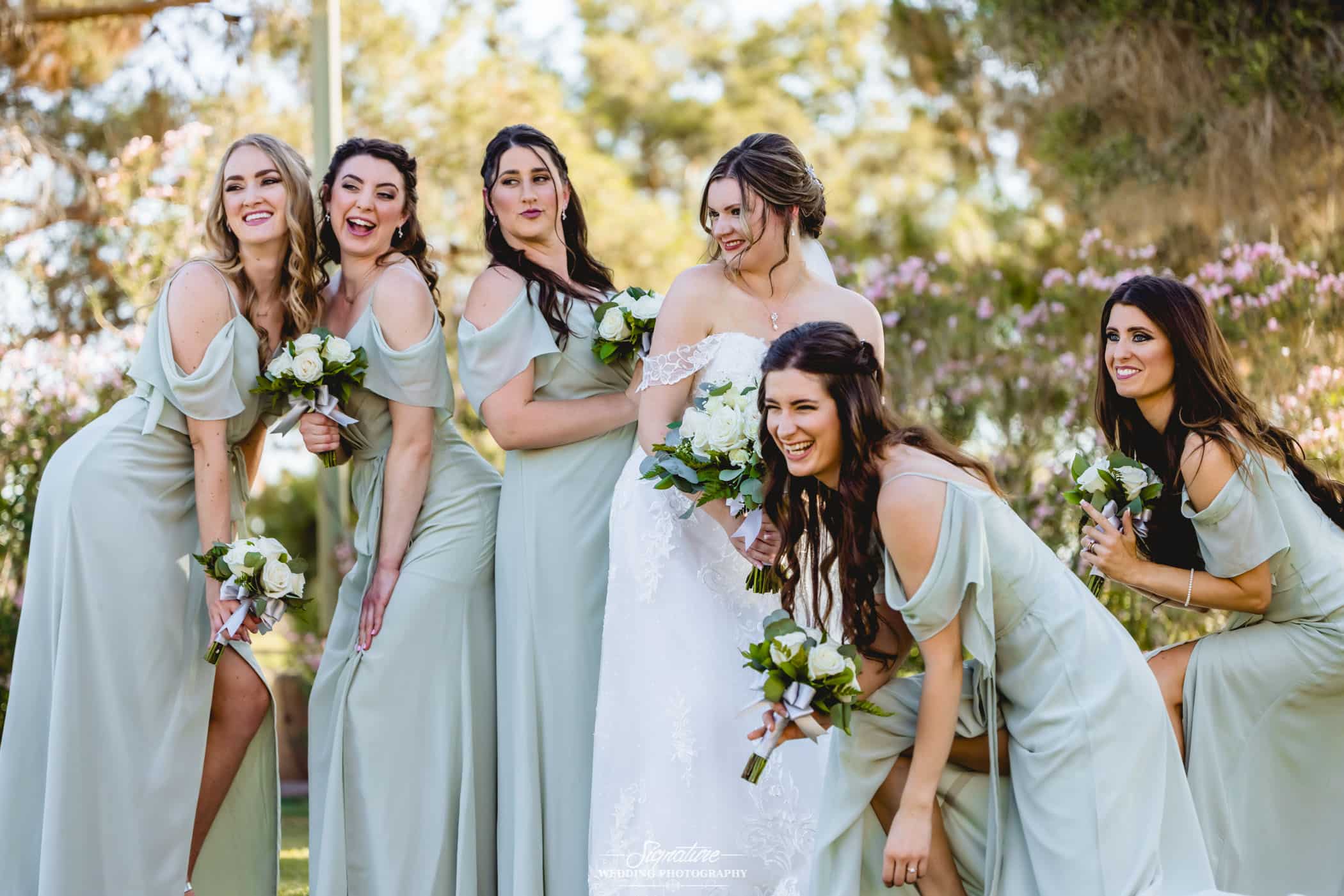 Bride with bridesmaids doing funny poses