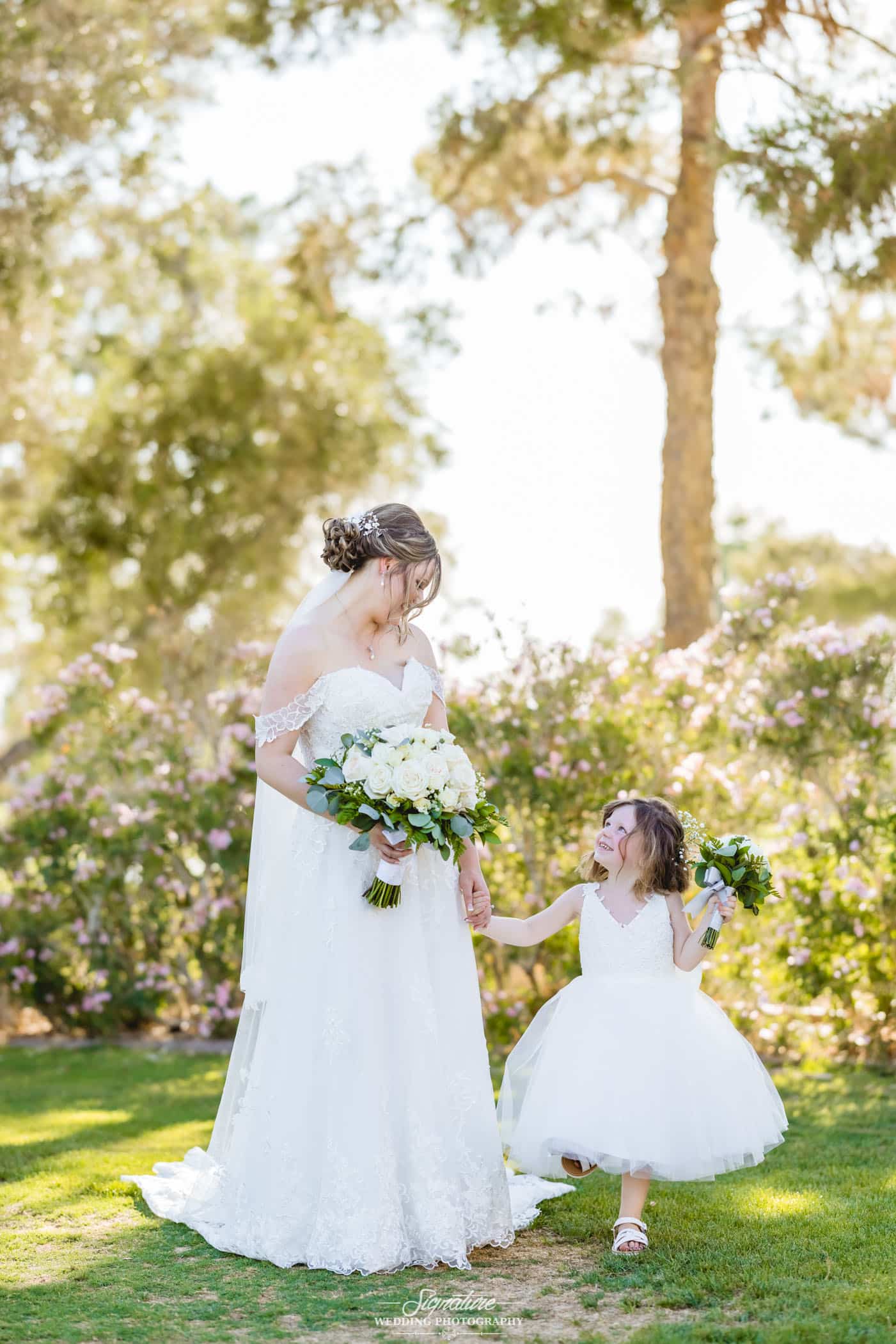 Bride holding hands with flower girl