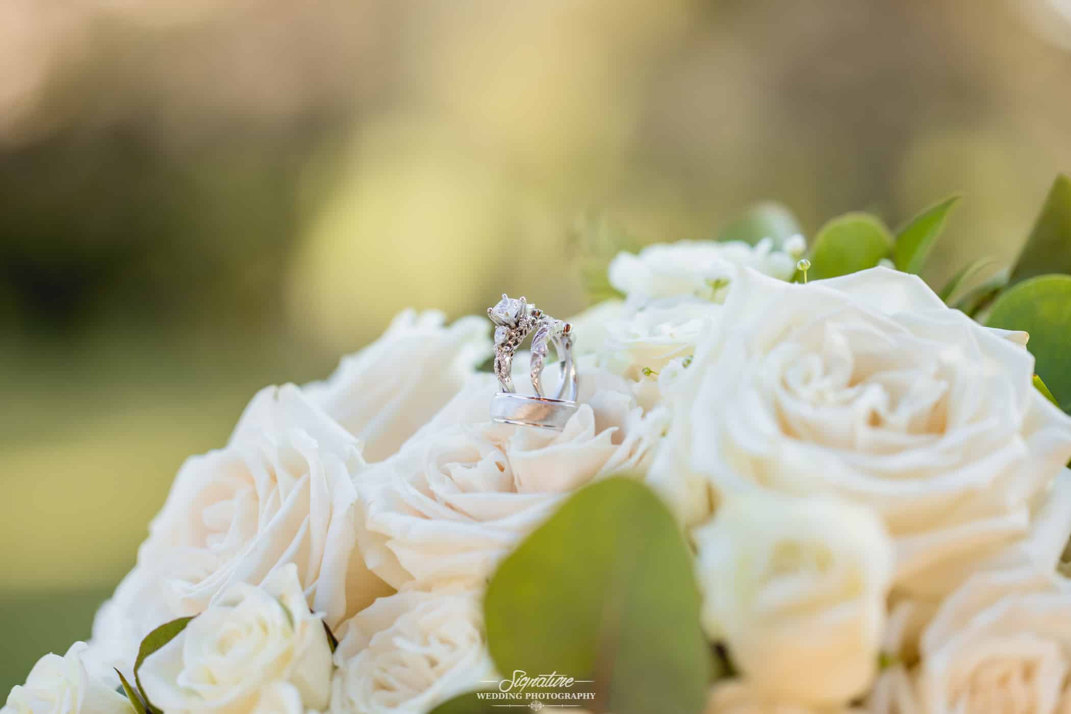 Close up of wedding rings on bouquet