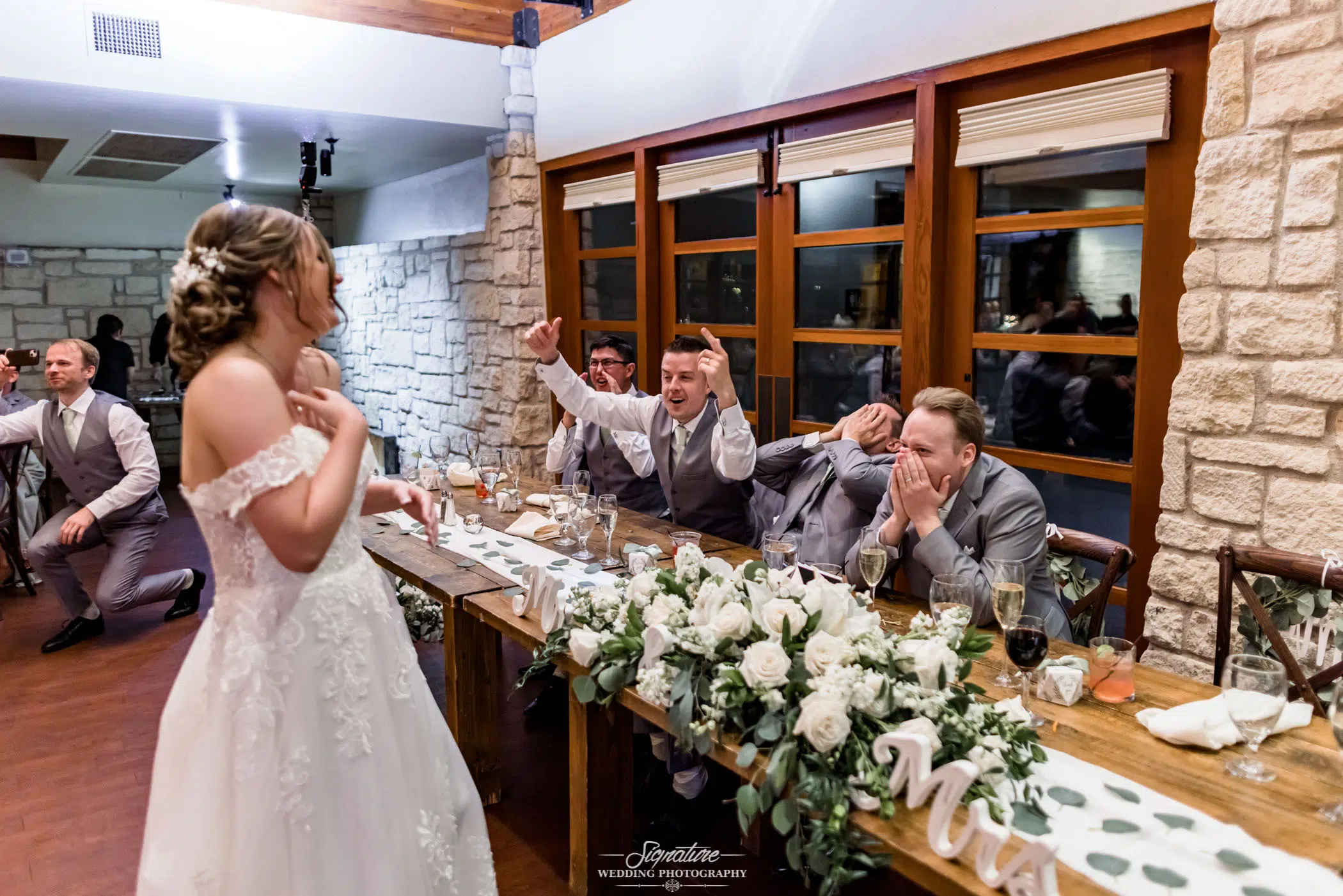 Bride walking past groomsmen