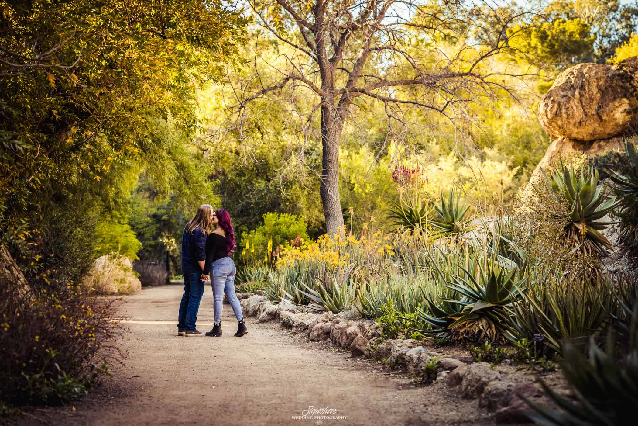 Couple kissing on desert path