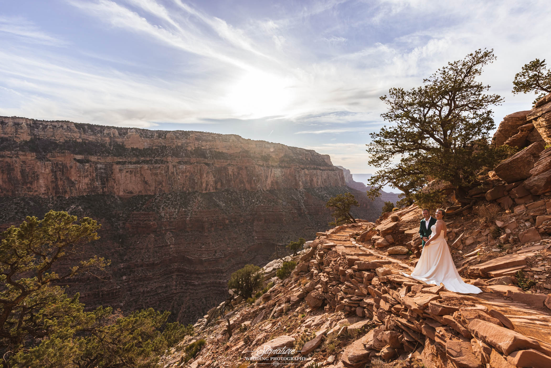 Bride and groom on desert mountain path
