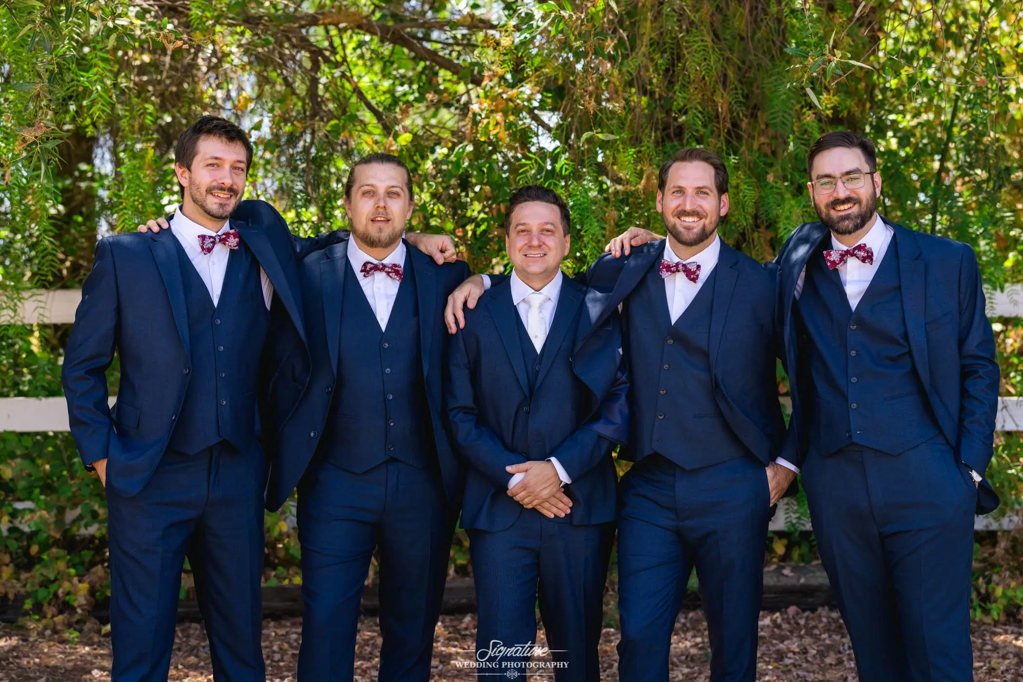 Groom with groomsmen smiling