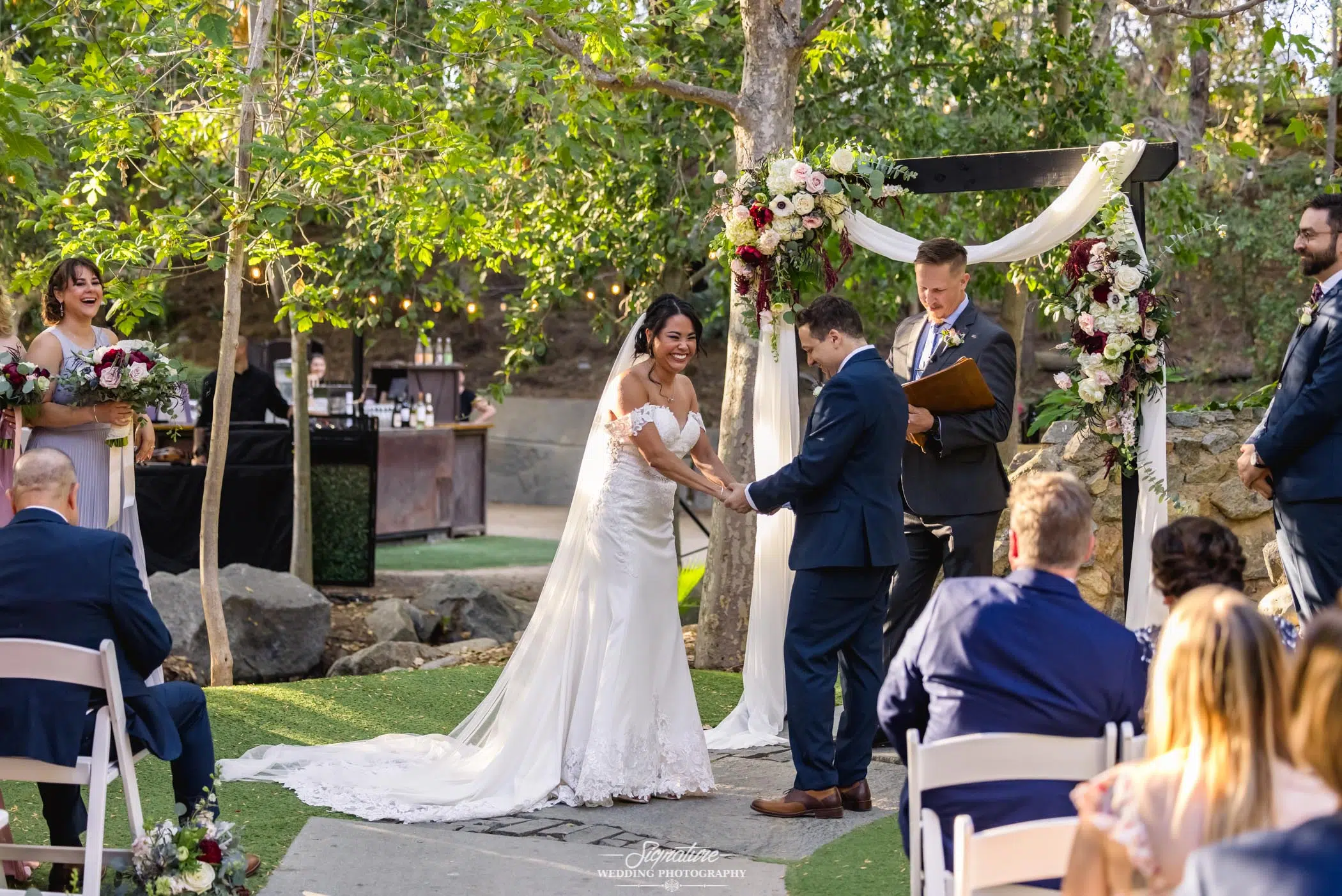 Bride and groom holding hands during ceremony