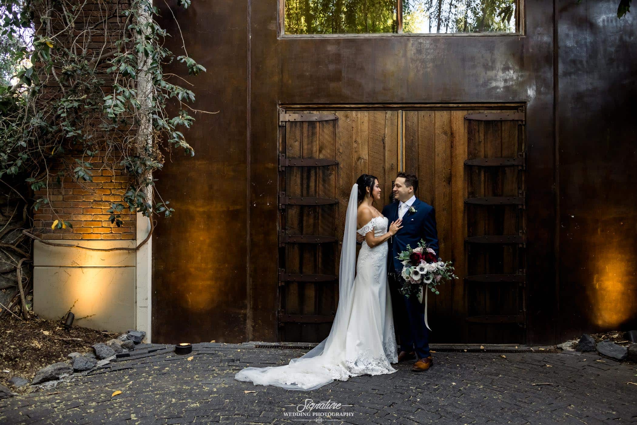 Bride and groom in front of wooden door