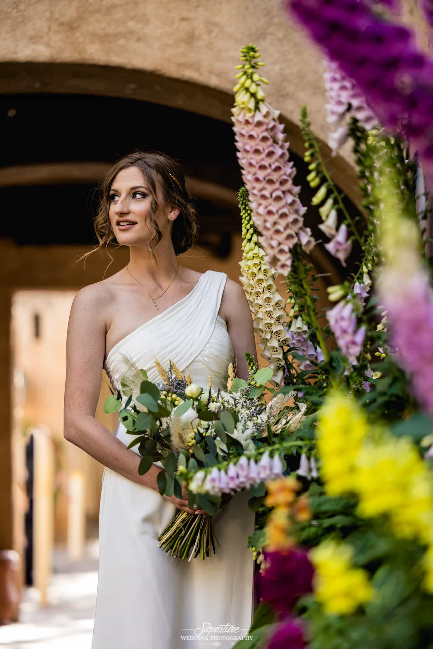 Bride looking off to side with bouquet
