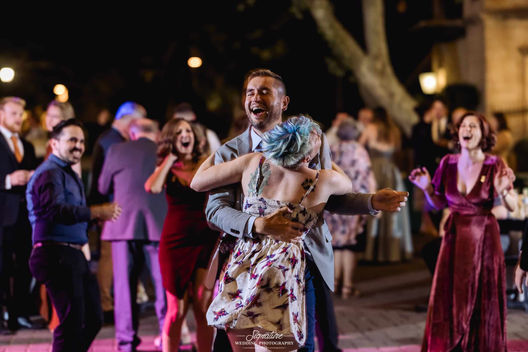 Wedding guests dancing together at reception