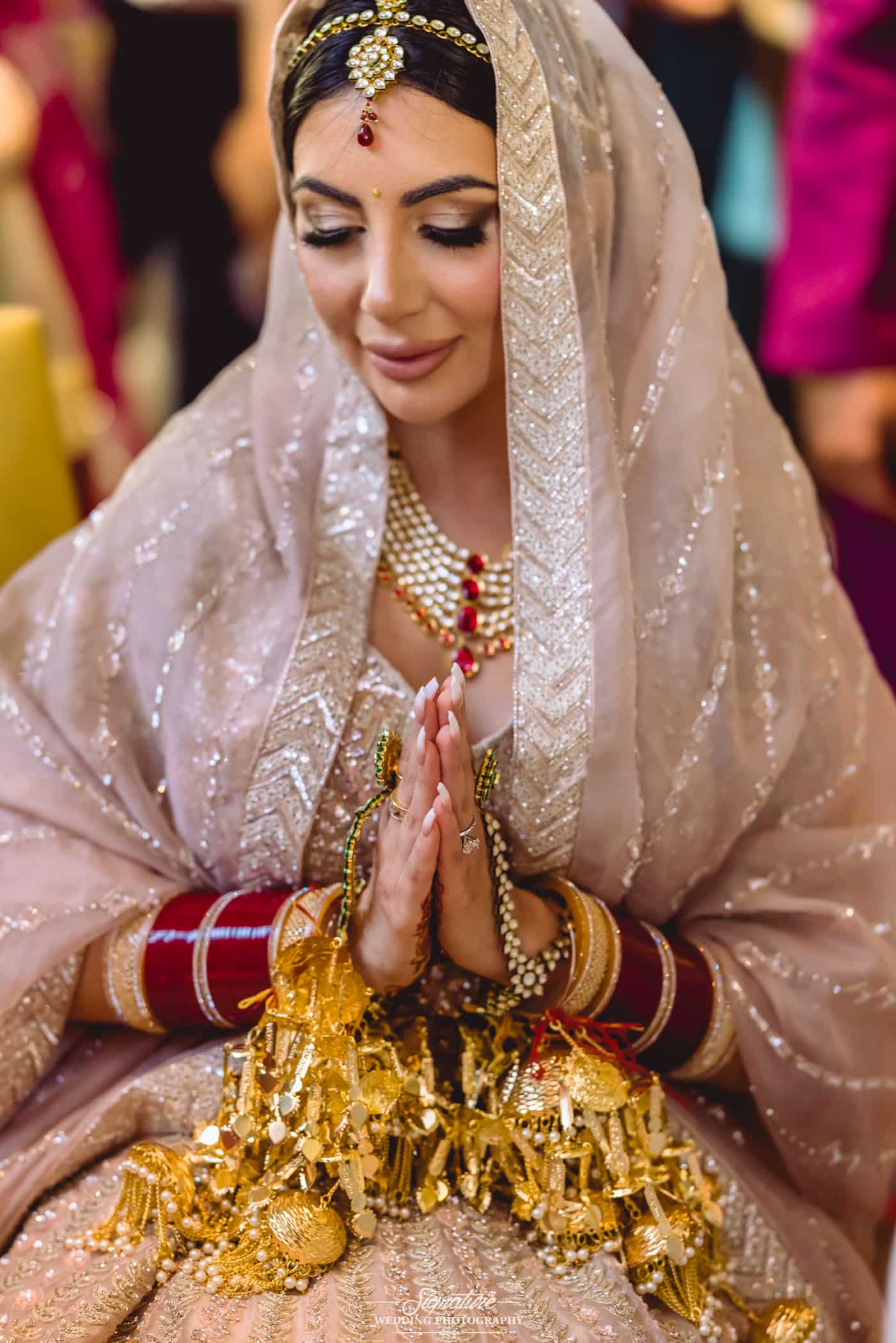 Indian bride holding hands together