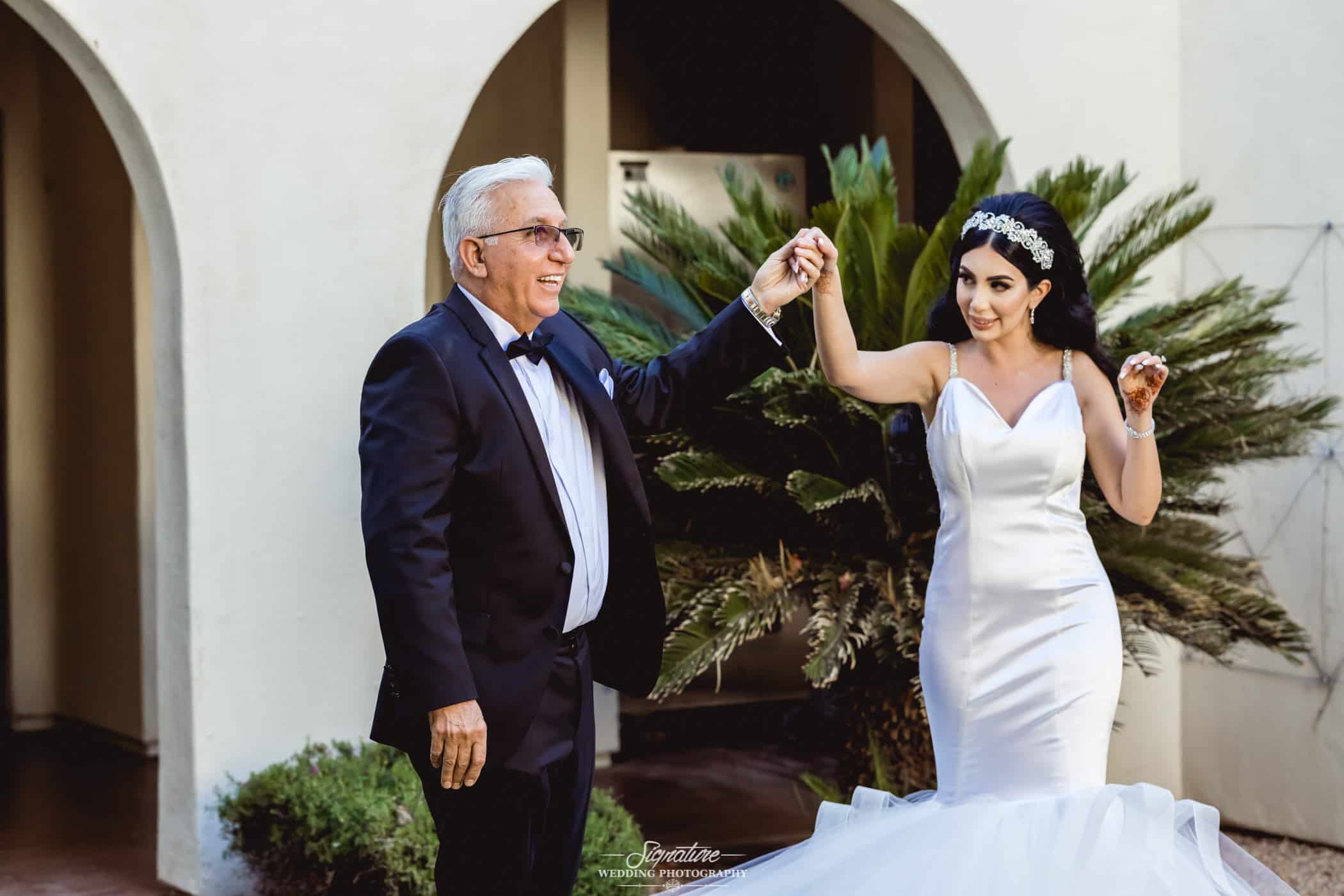 Bride holding hands with father