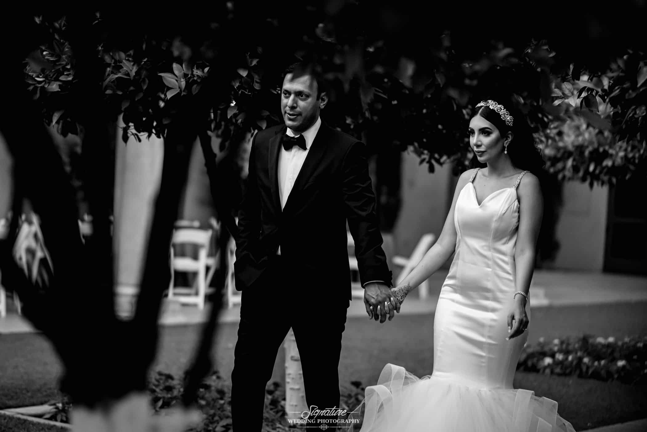 Bride and groom holding hands black and white