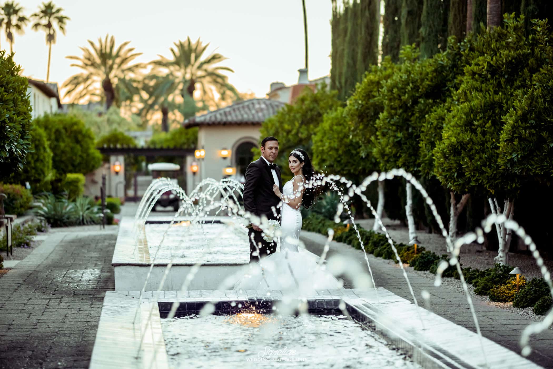 Bride and groom between water fountains