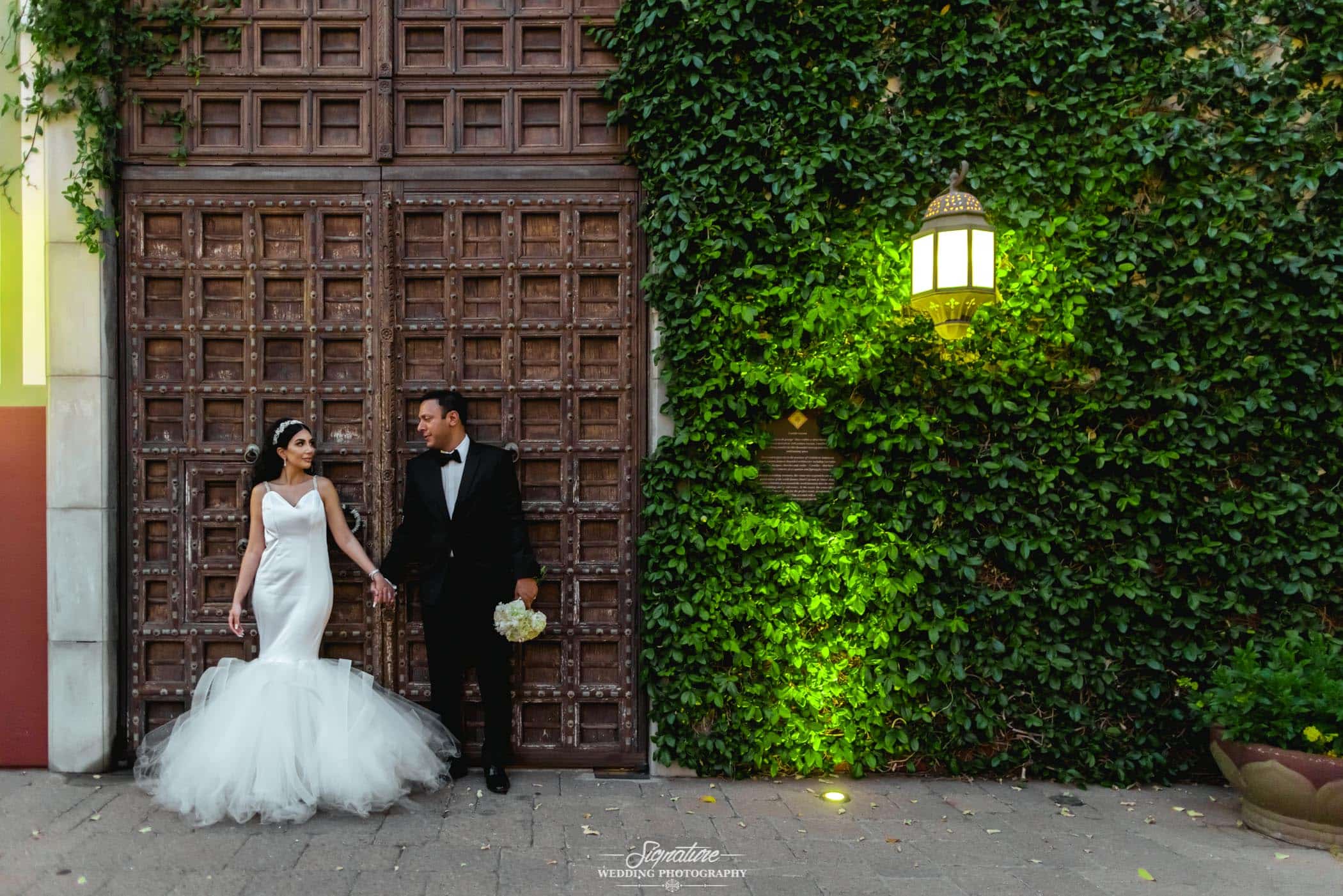 Bride and groom in front of big door