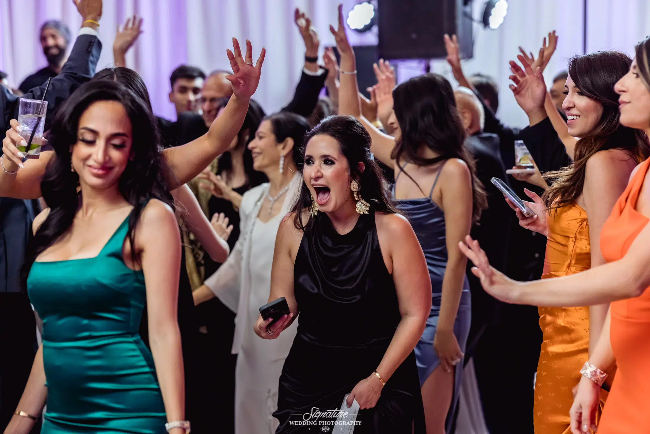 Wedding guests smiling and dancing