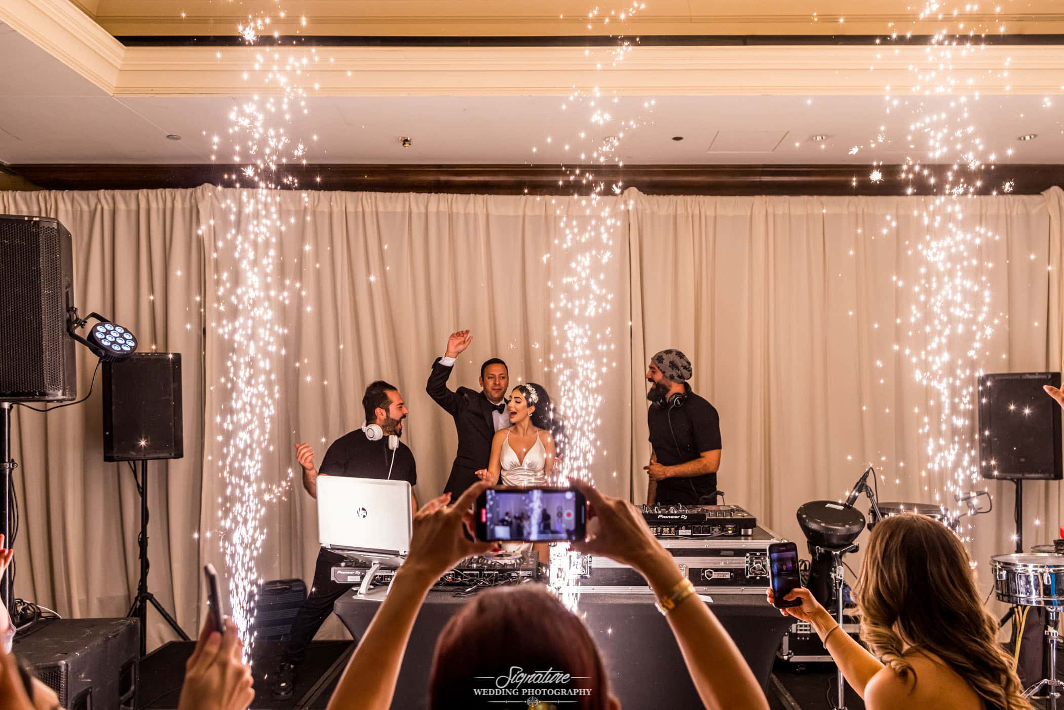 Bride and groom on stage with DJ