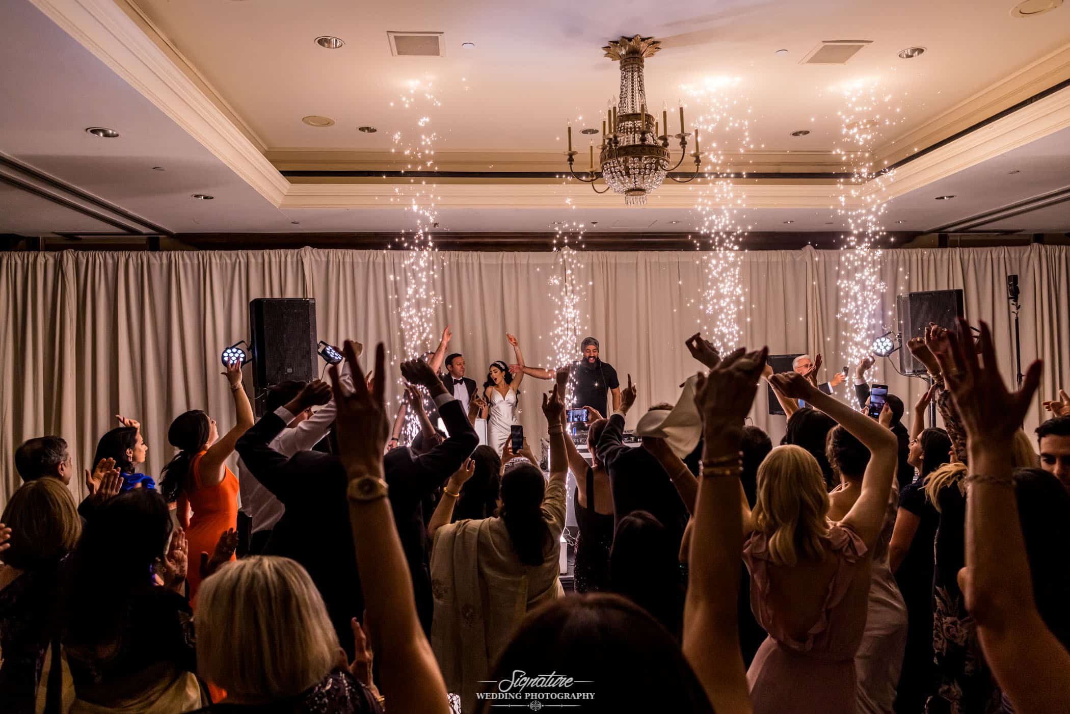 Wedding guests dancing while sparks fly