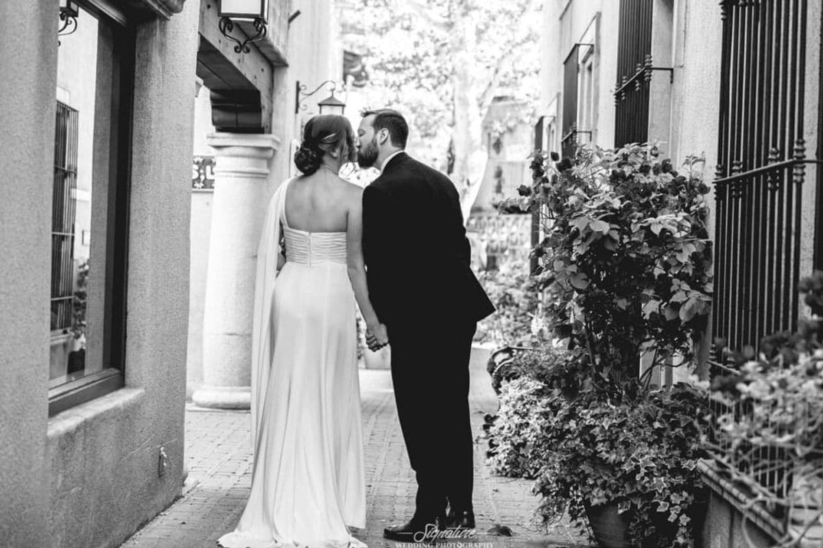 Bride and groom kissing black and white