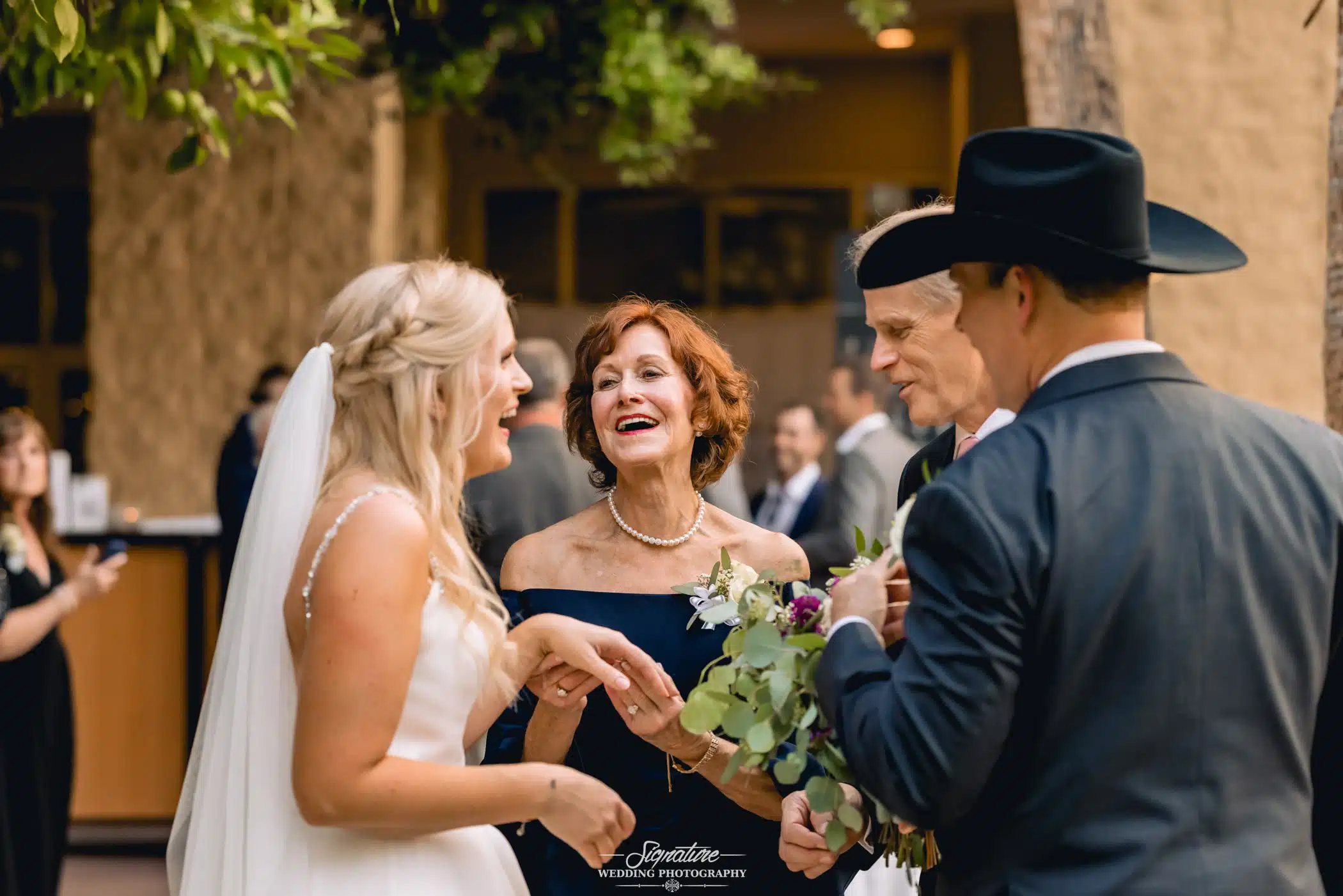Bride and groom talking to wedding guests