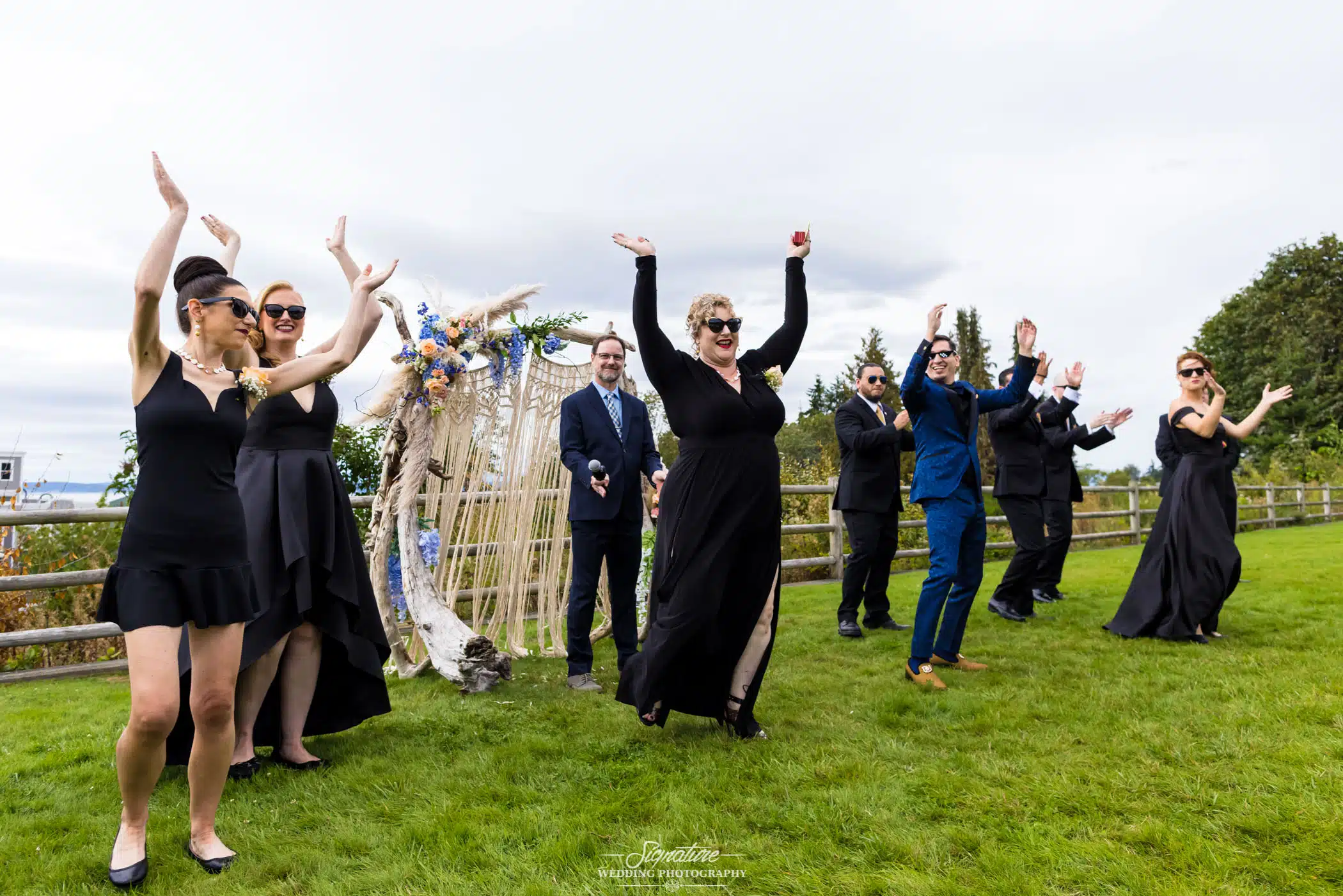 Wedding party with arms in air