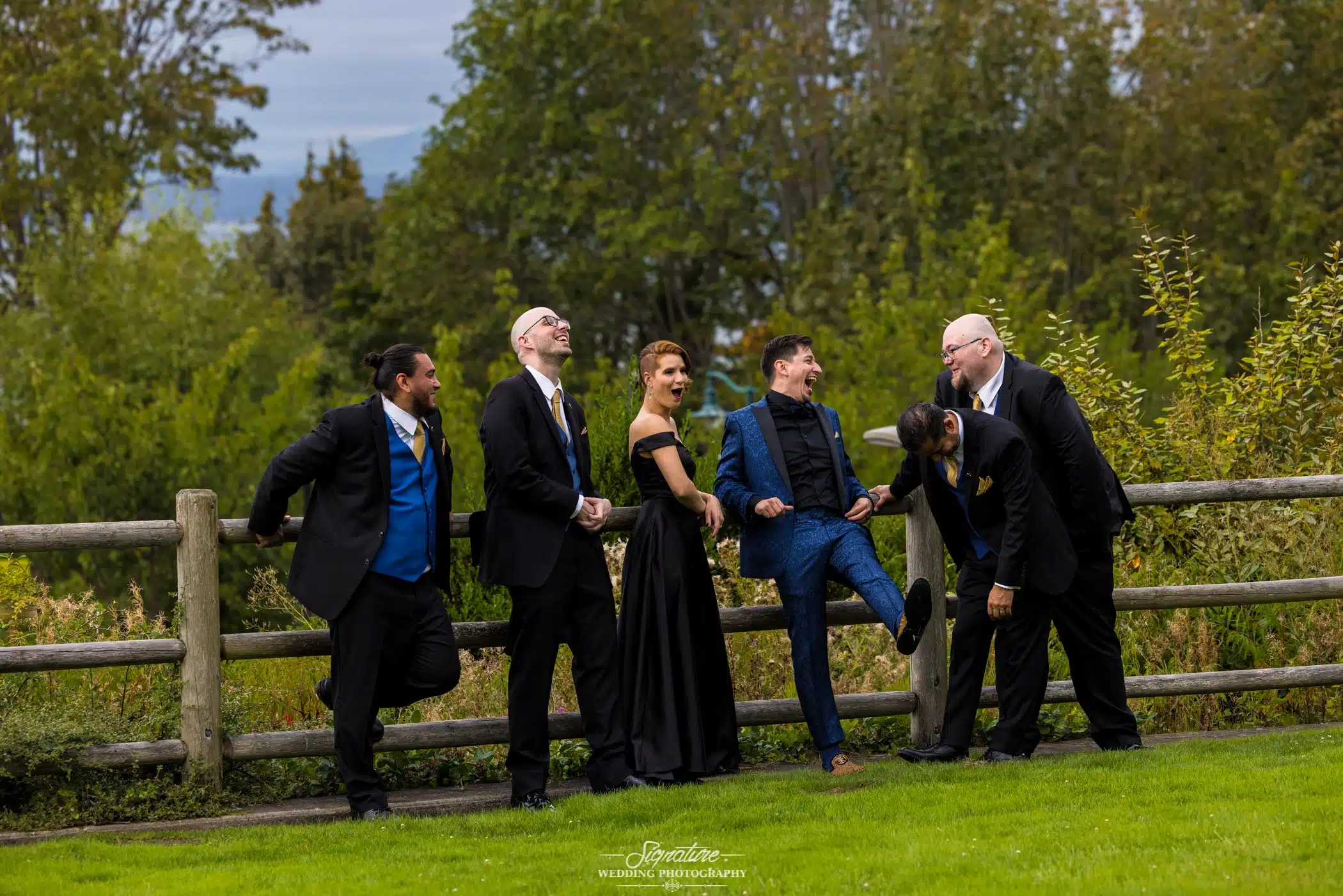 Groom laughing with groomspeople