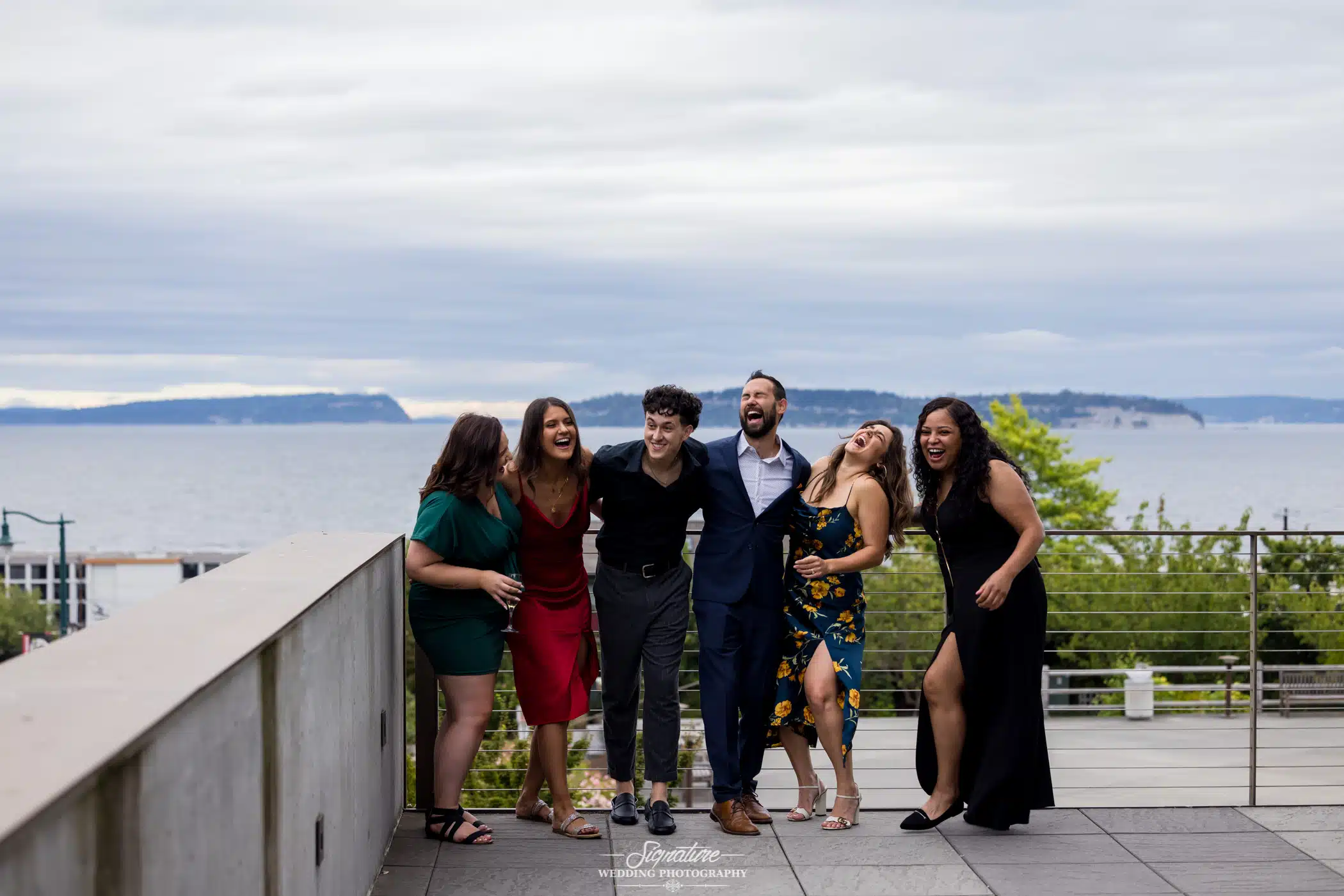 Wedding guests laughing on balcony