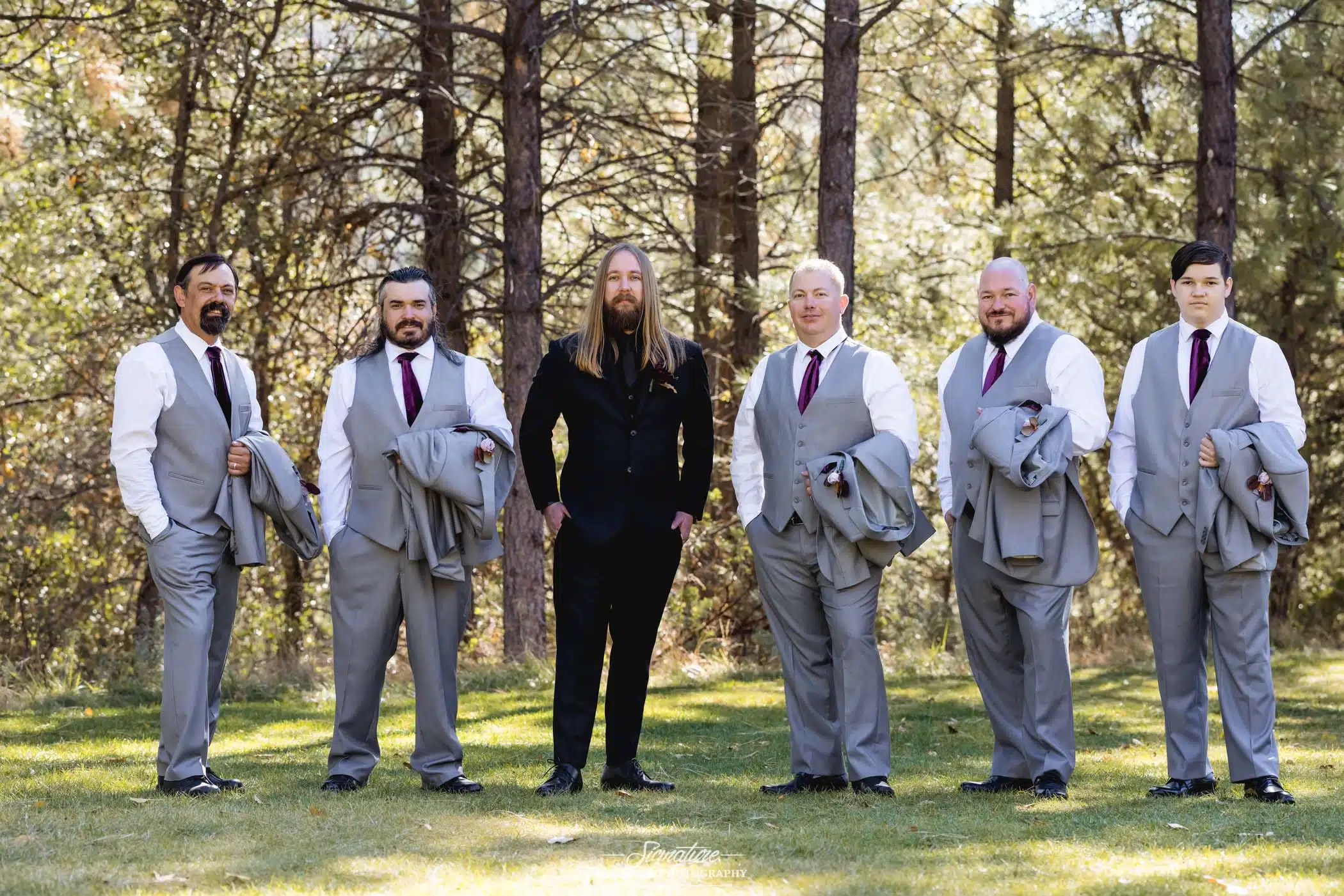 Groom and groomsmen smiling