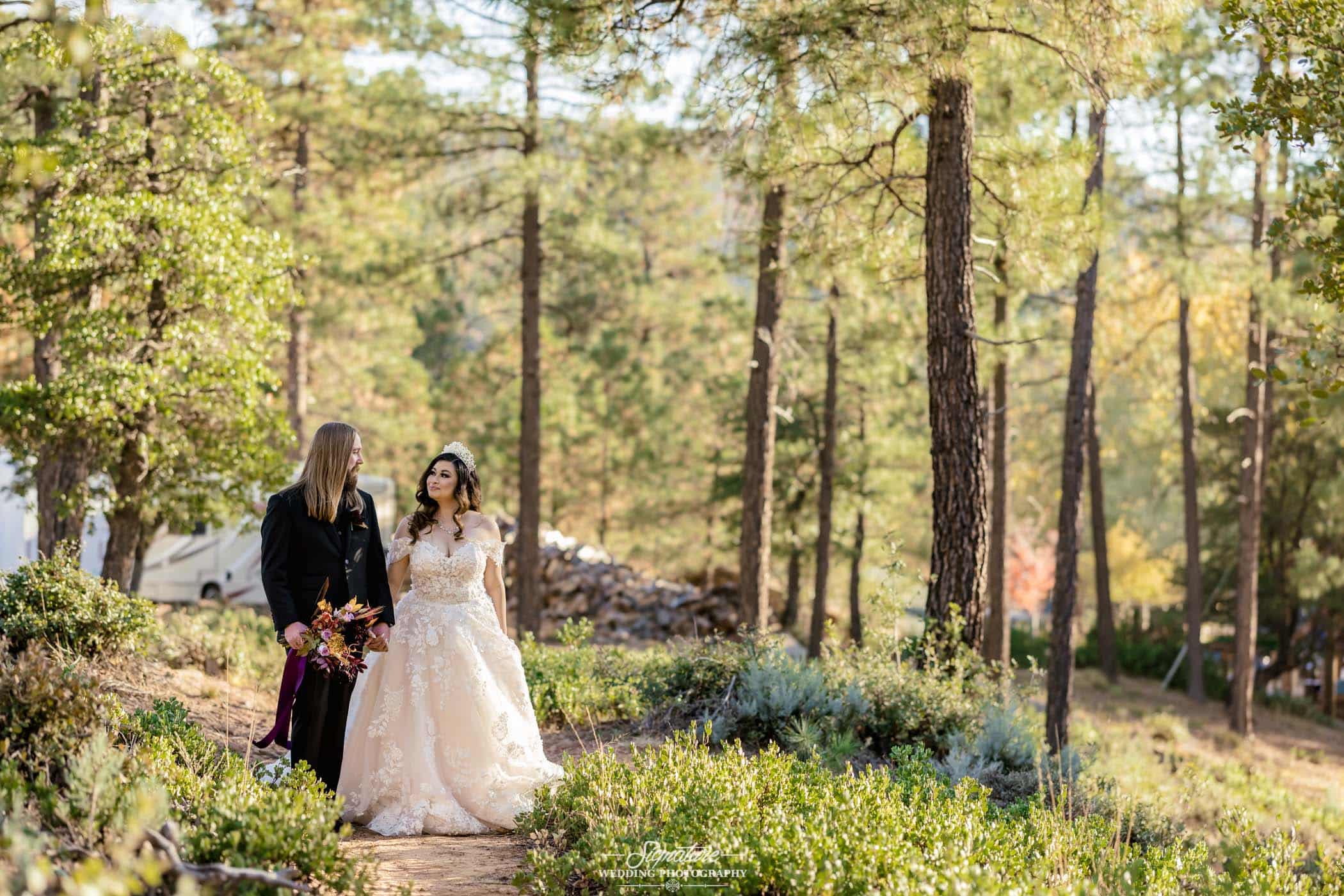 Bride and groom standing in forest