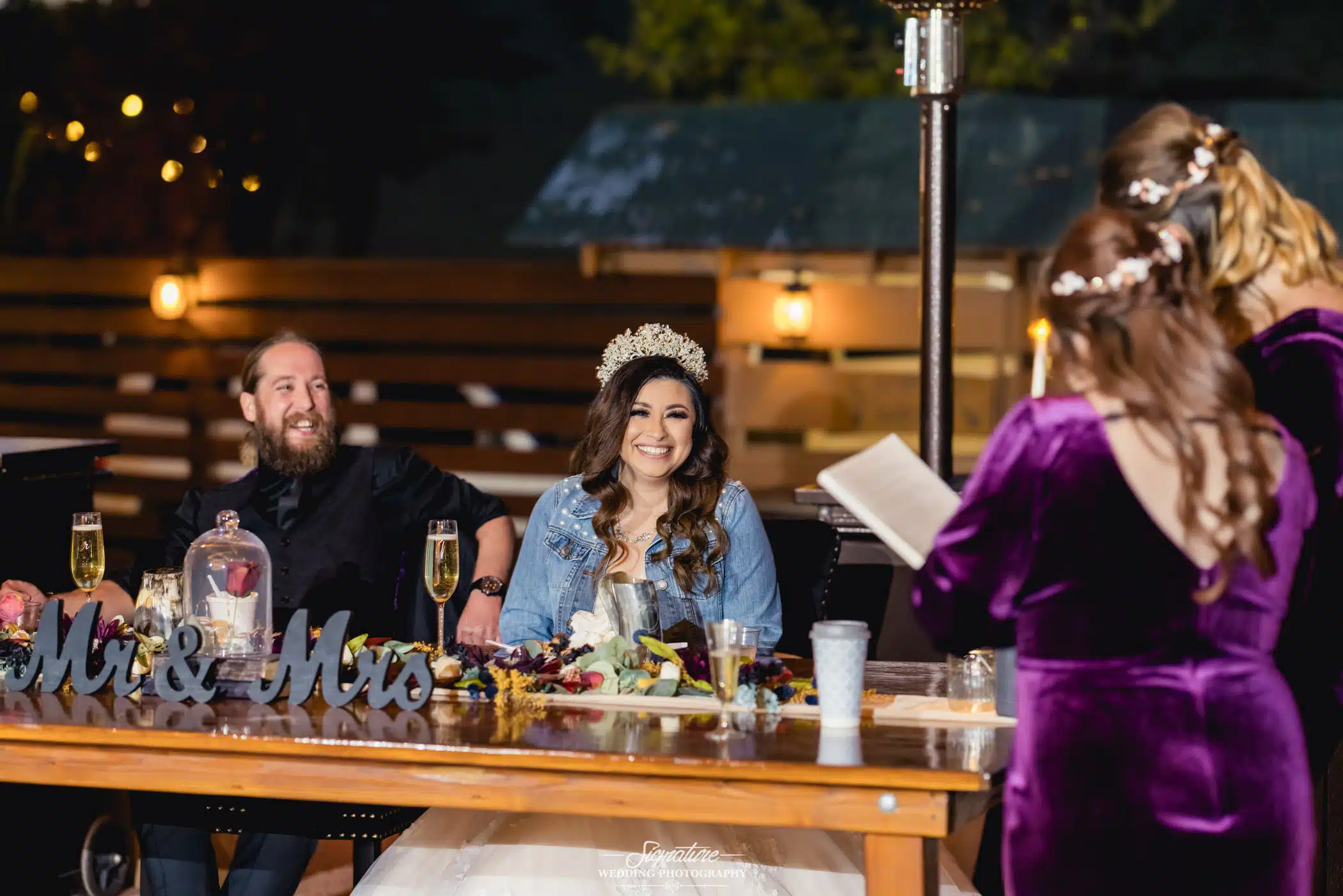 Bride and groom listening to speeches