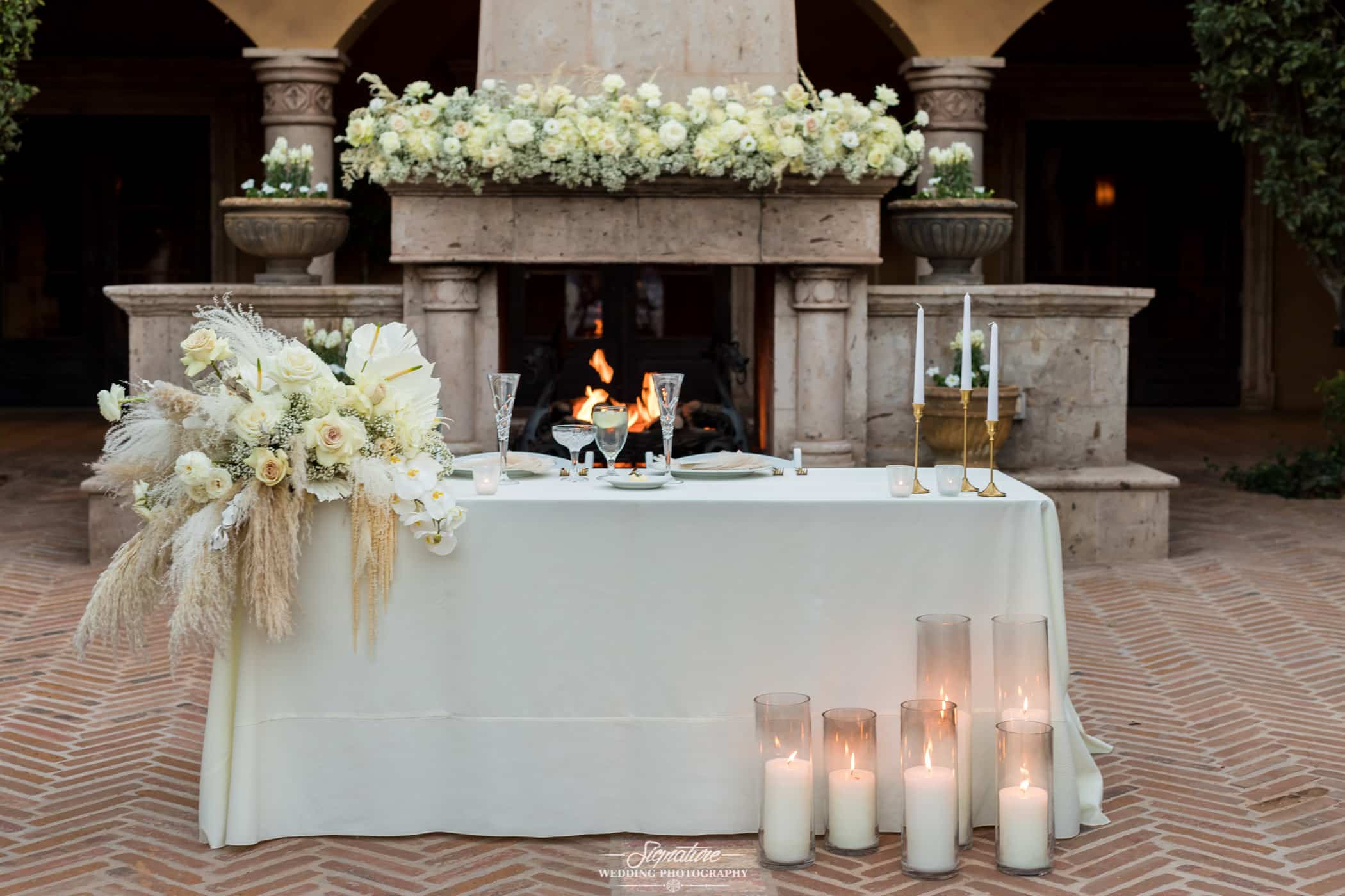 Sweetheart table in front of fireplace