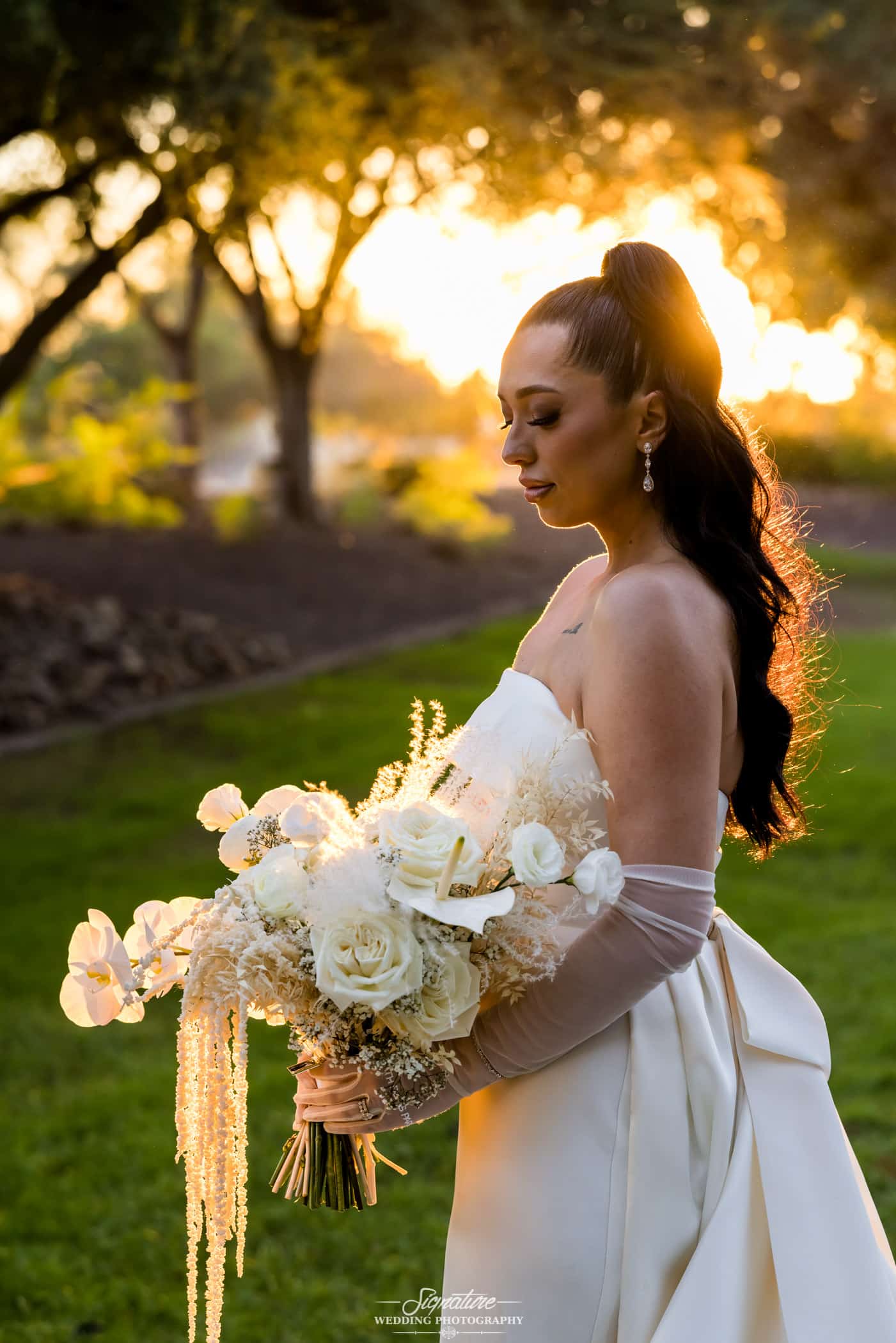 Bride holding bouquet at sunset