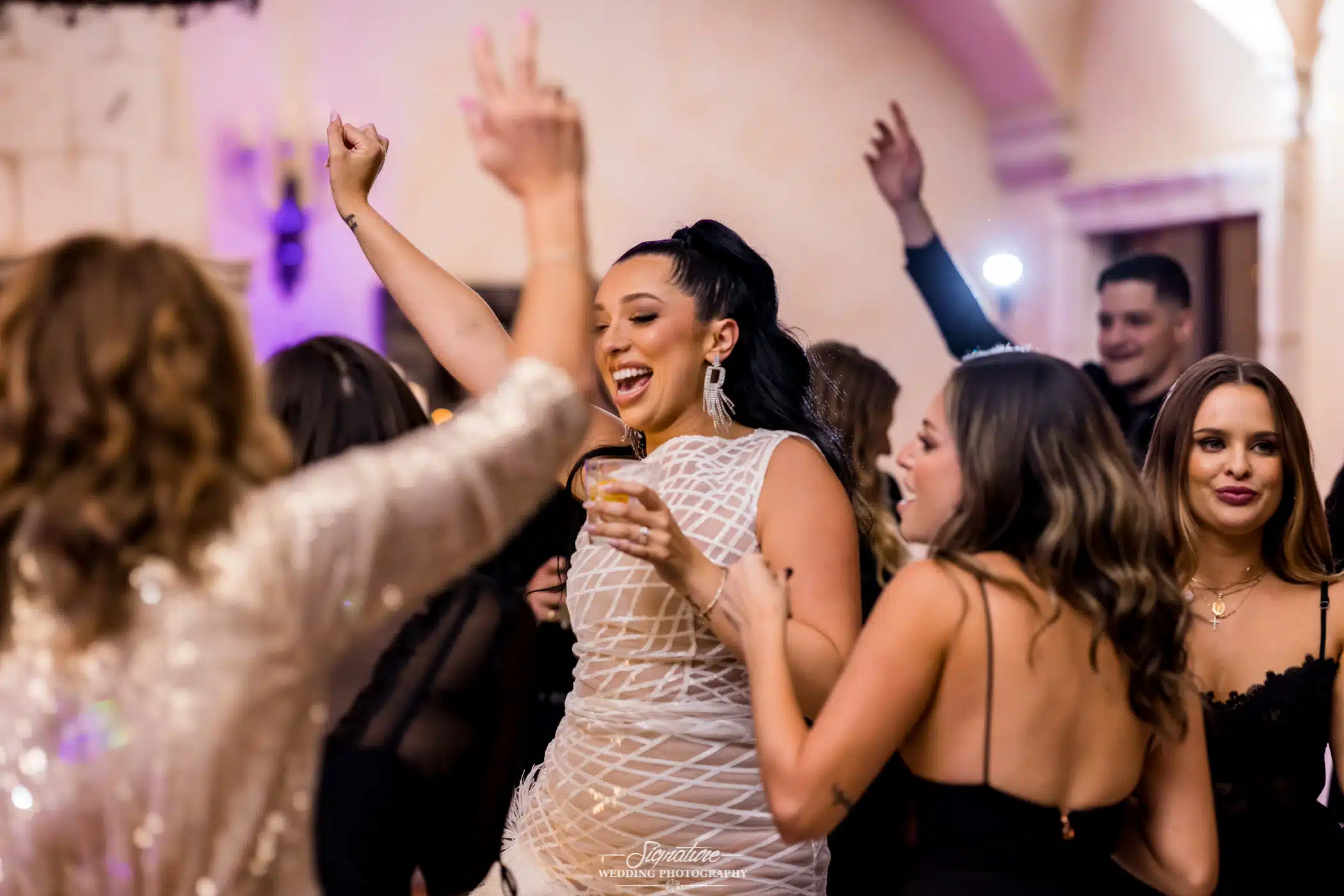 Bride dancing with wedding guests