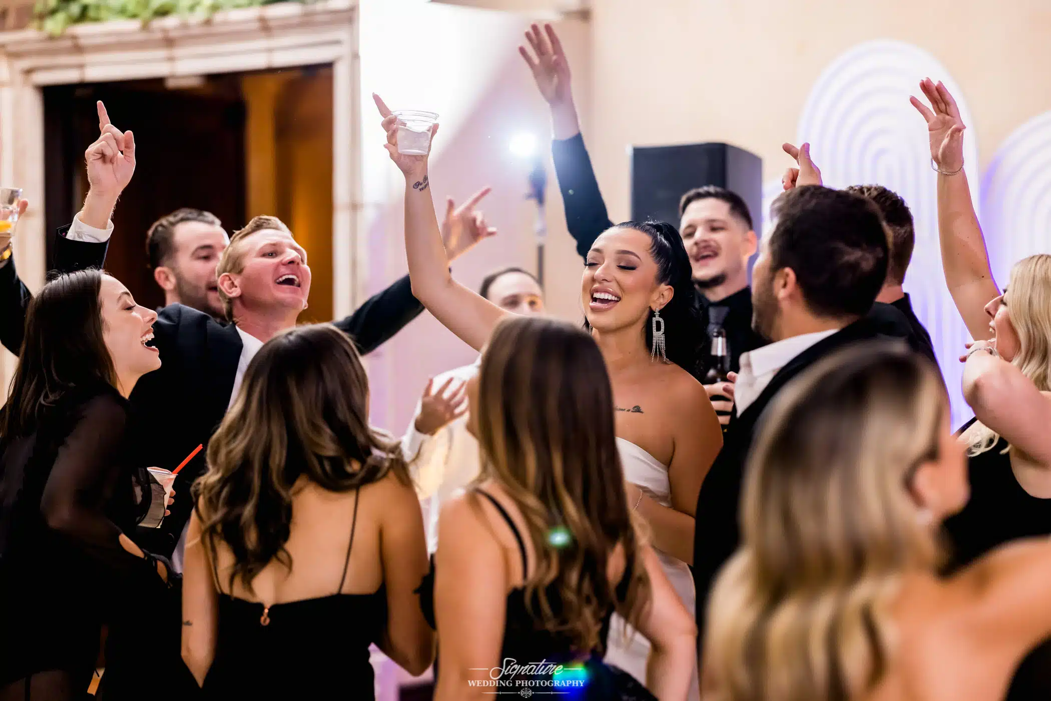 Bride and groom dancing with wedding guests