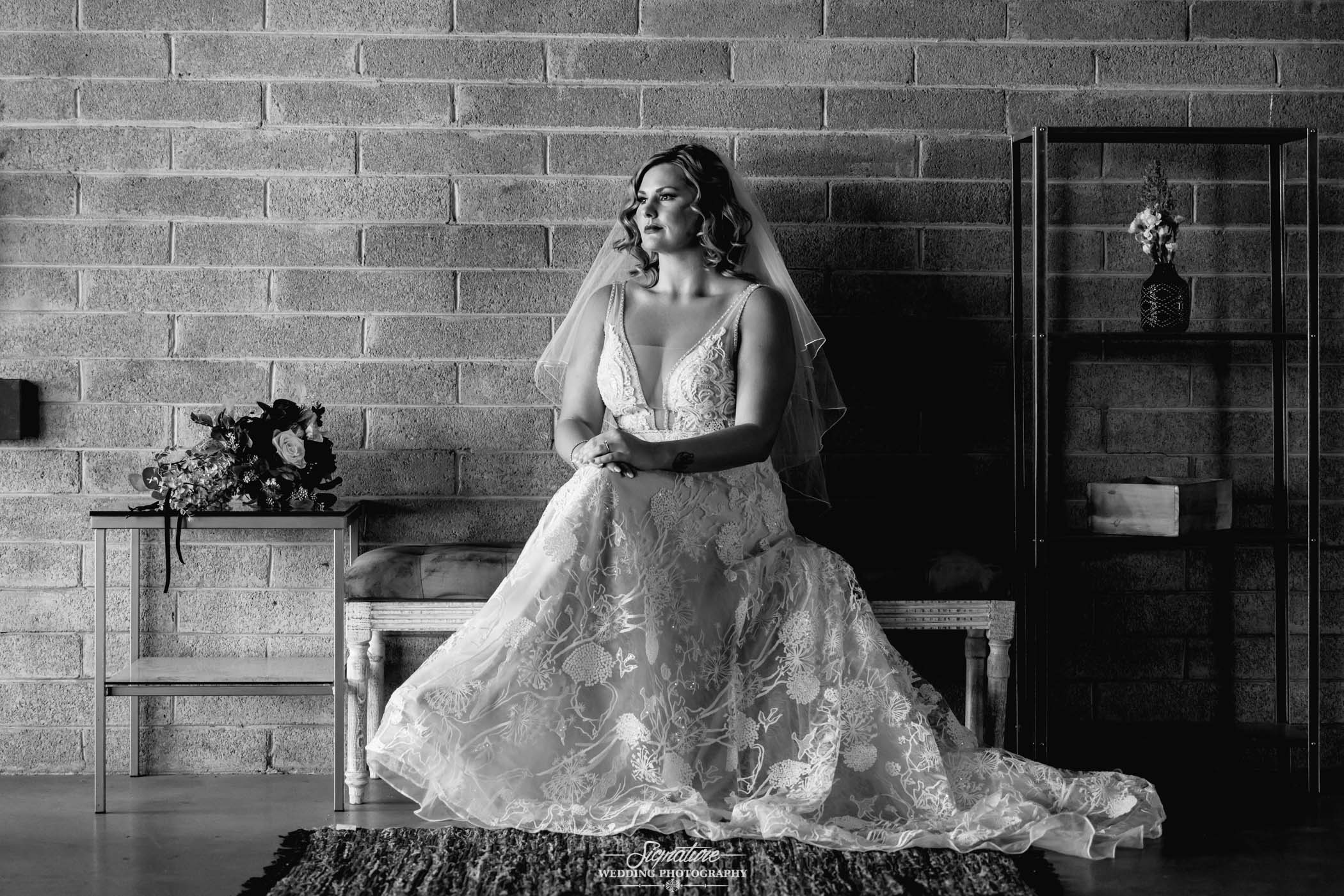 Bride sitting in wedding dress black and white