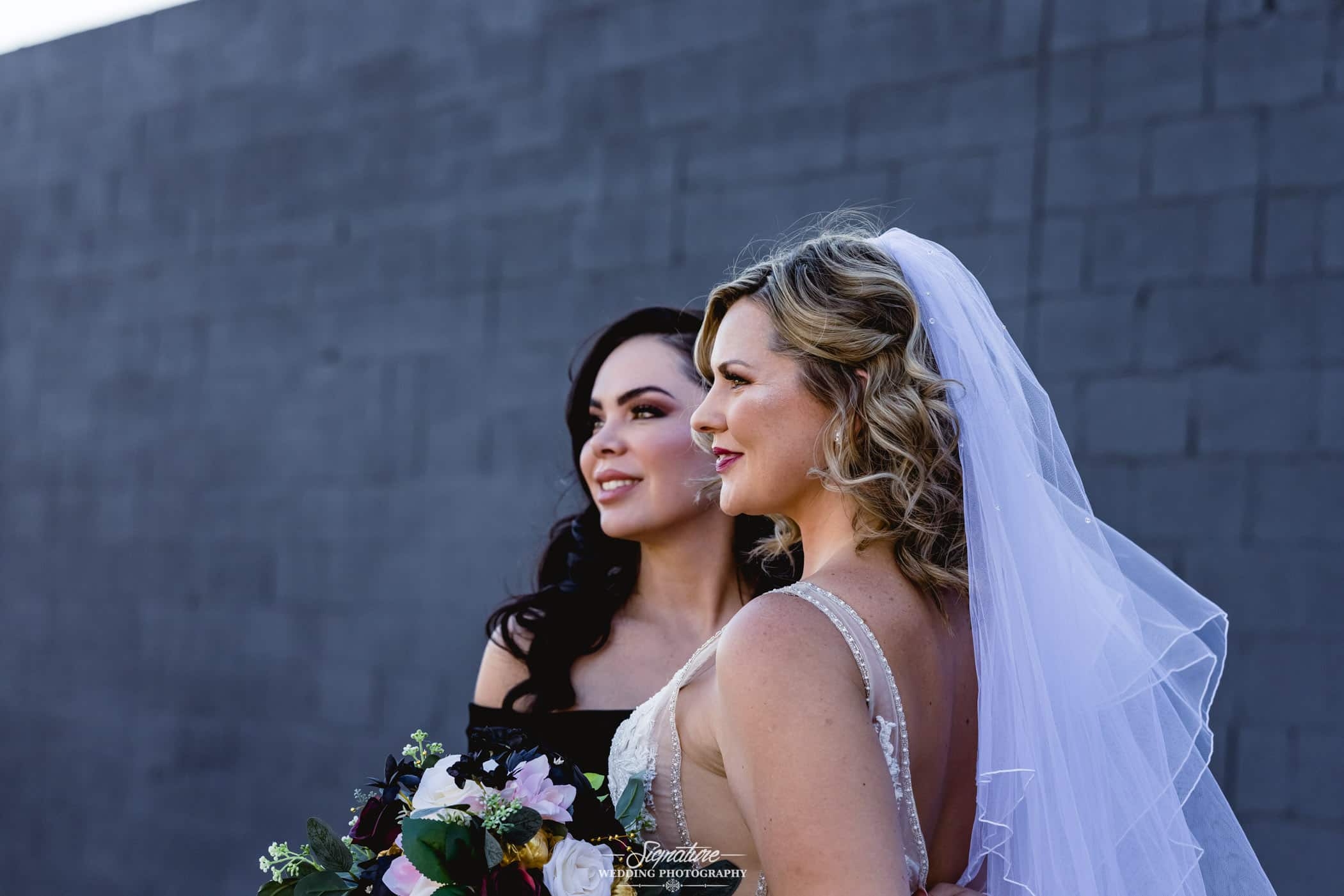 Bride and bridesmaid smiling