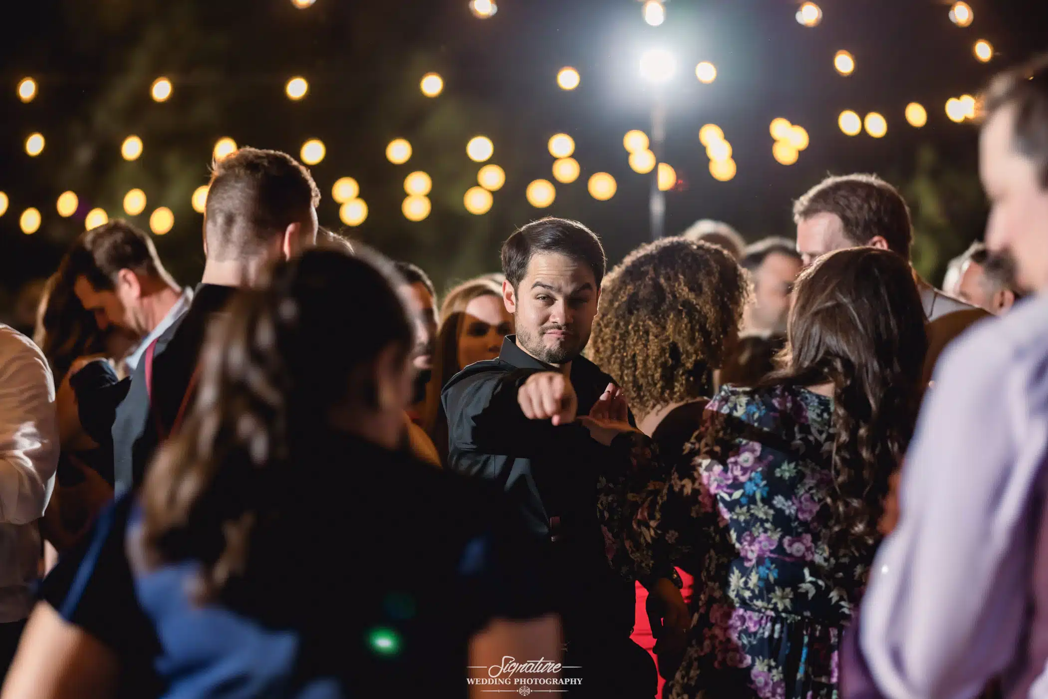 Man pointing at camera on dance floor