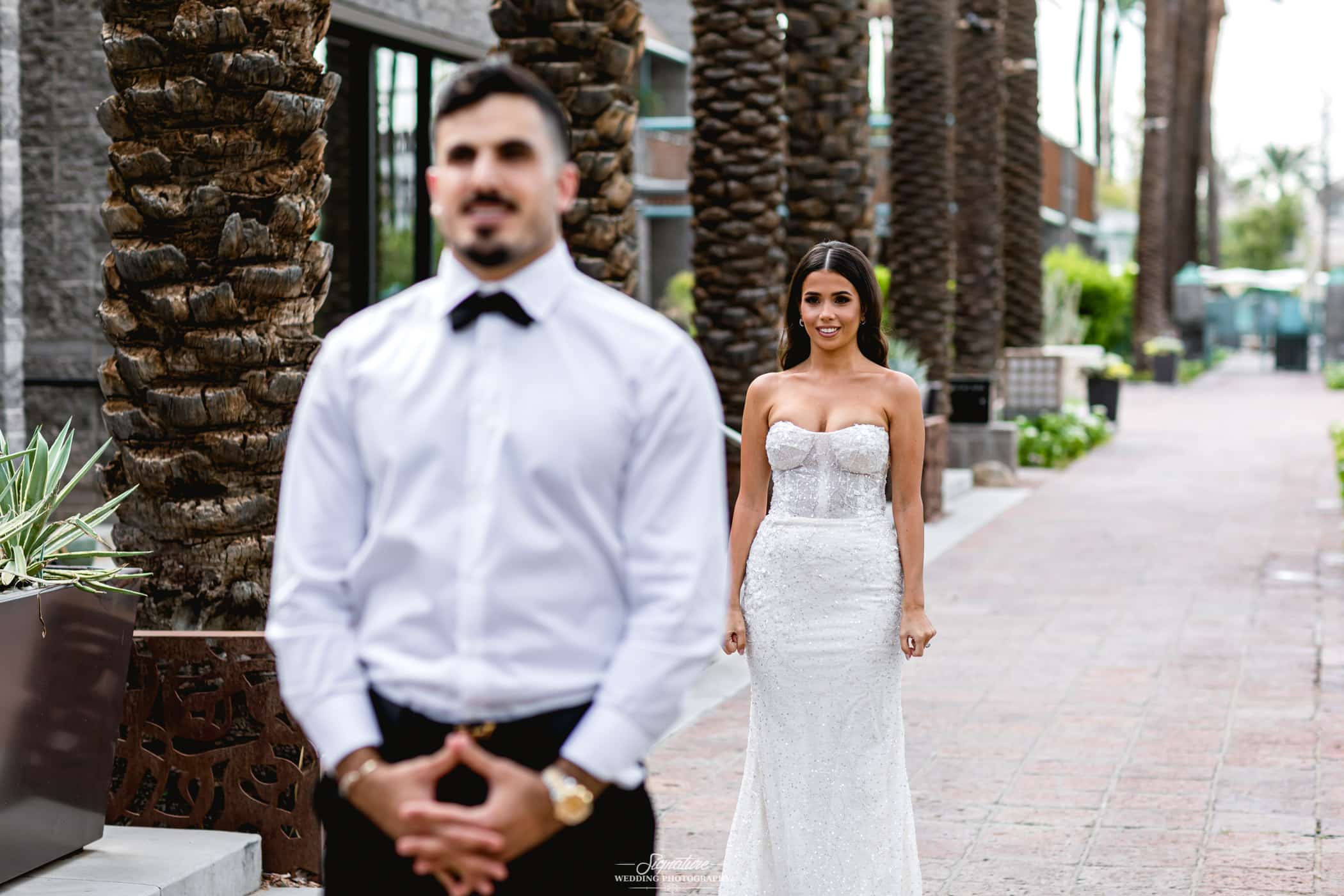 Bride standing behind groom for first look