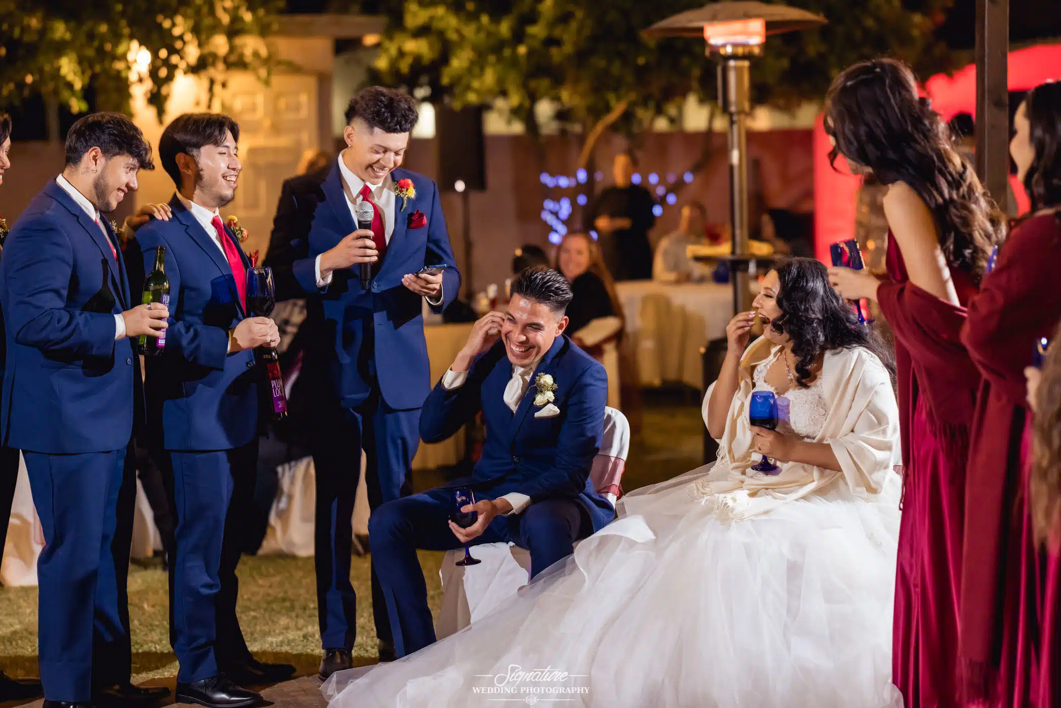 Bride and groom seated listening to speeches