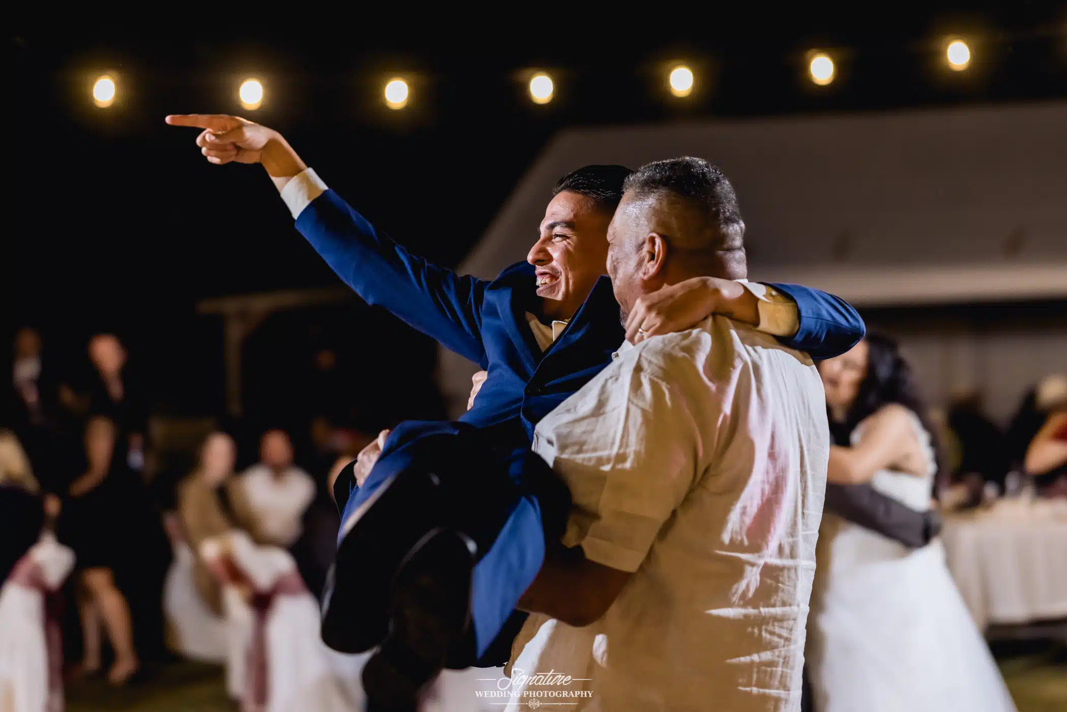 Man holding other man in arms