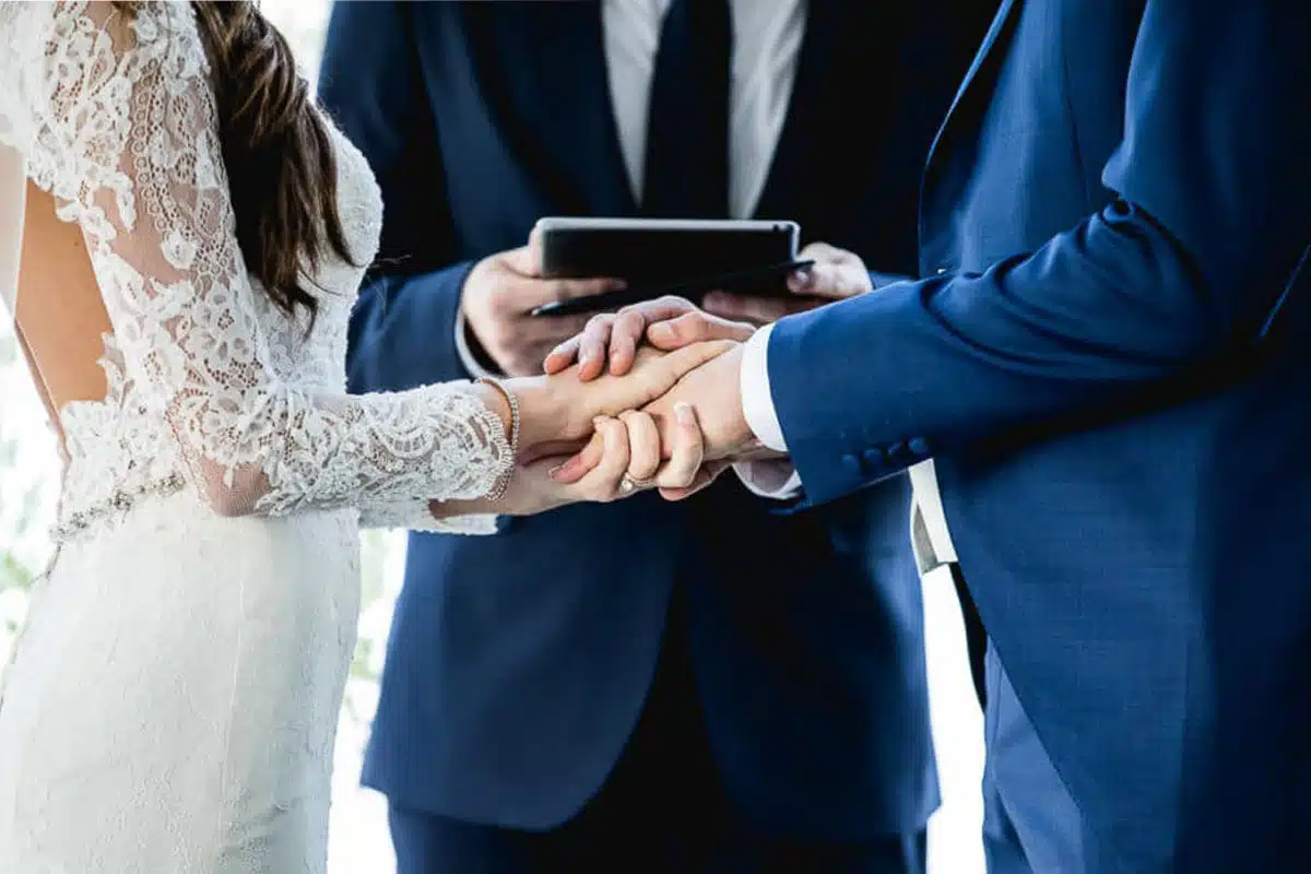Couple holding hands during ceremony