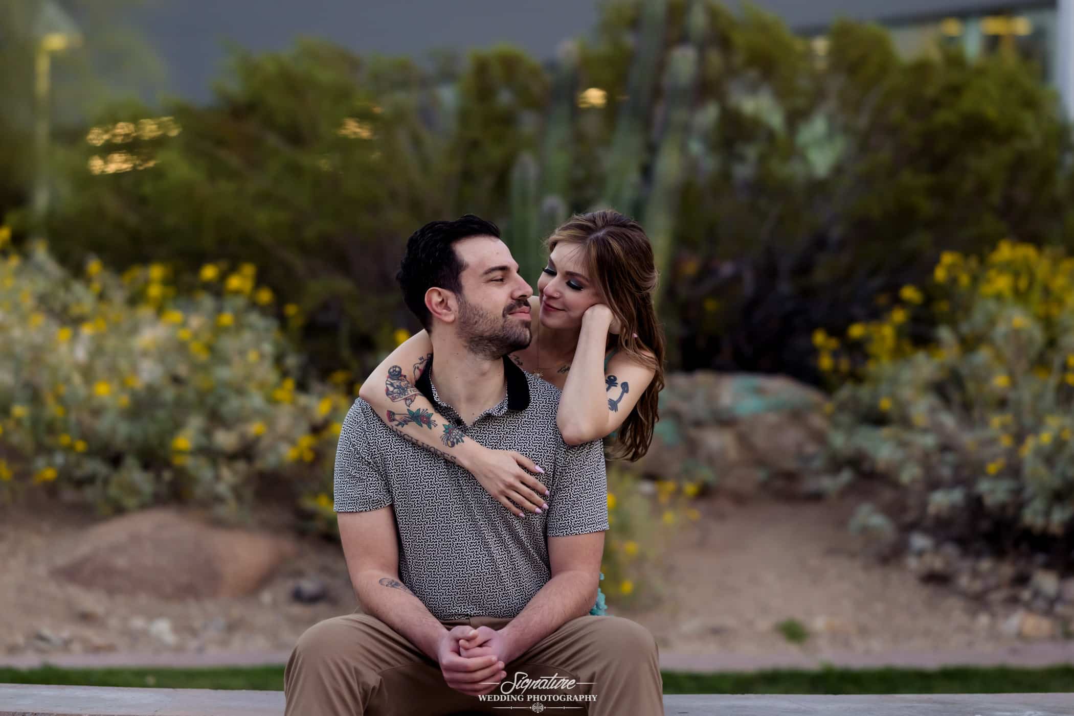 Woman's arm around man's shoulders engagement photo