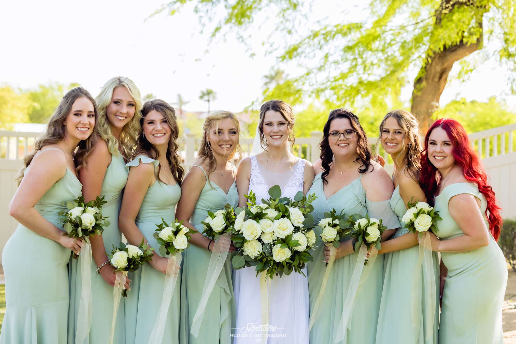 Bride with bridesmaids smiling 