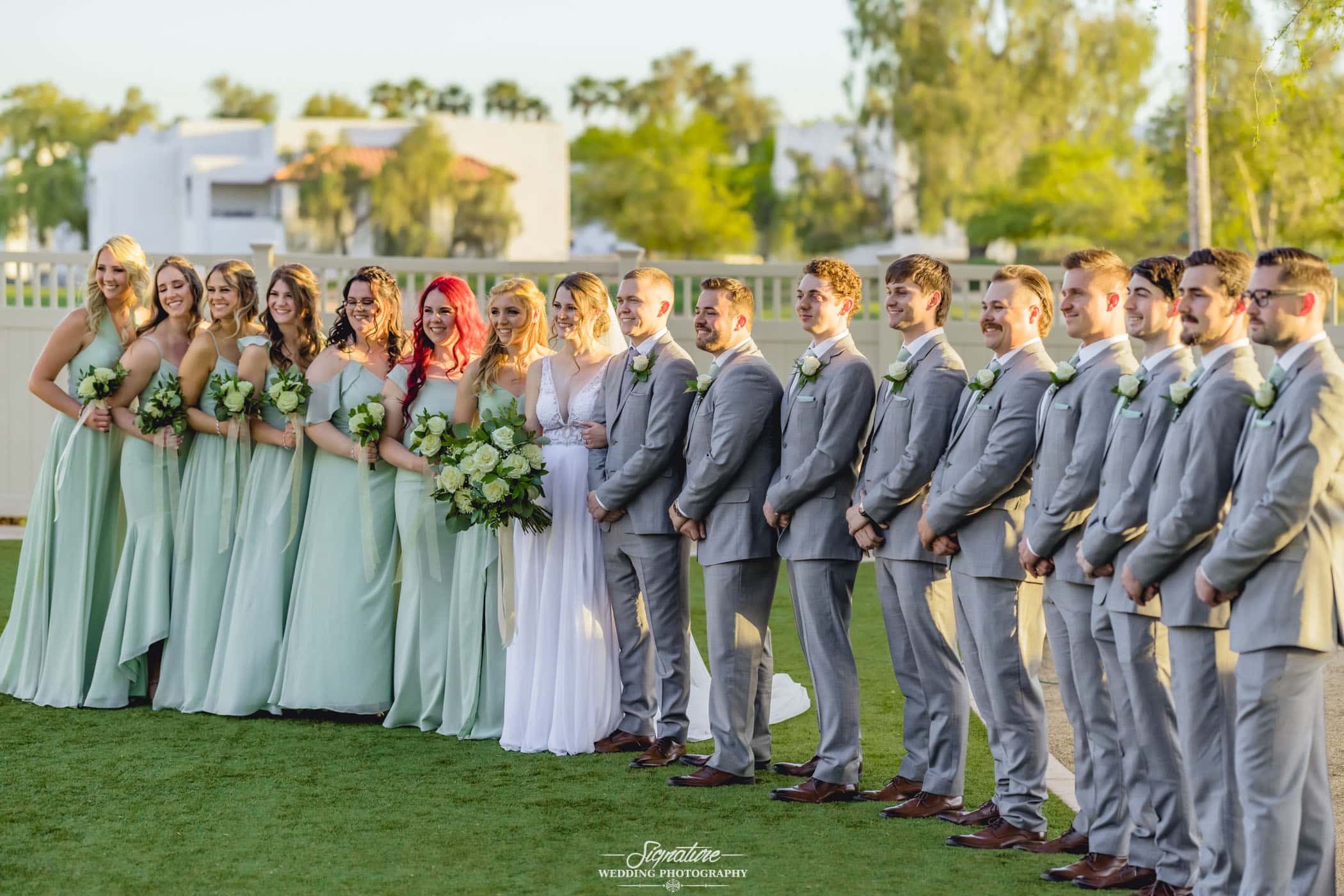 Bride and groom with wedding party smiling