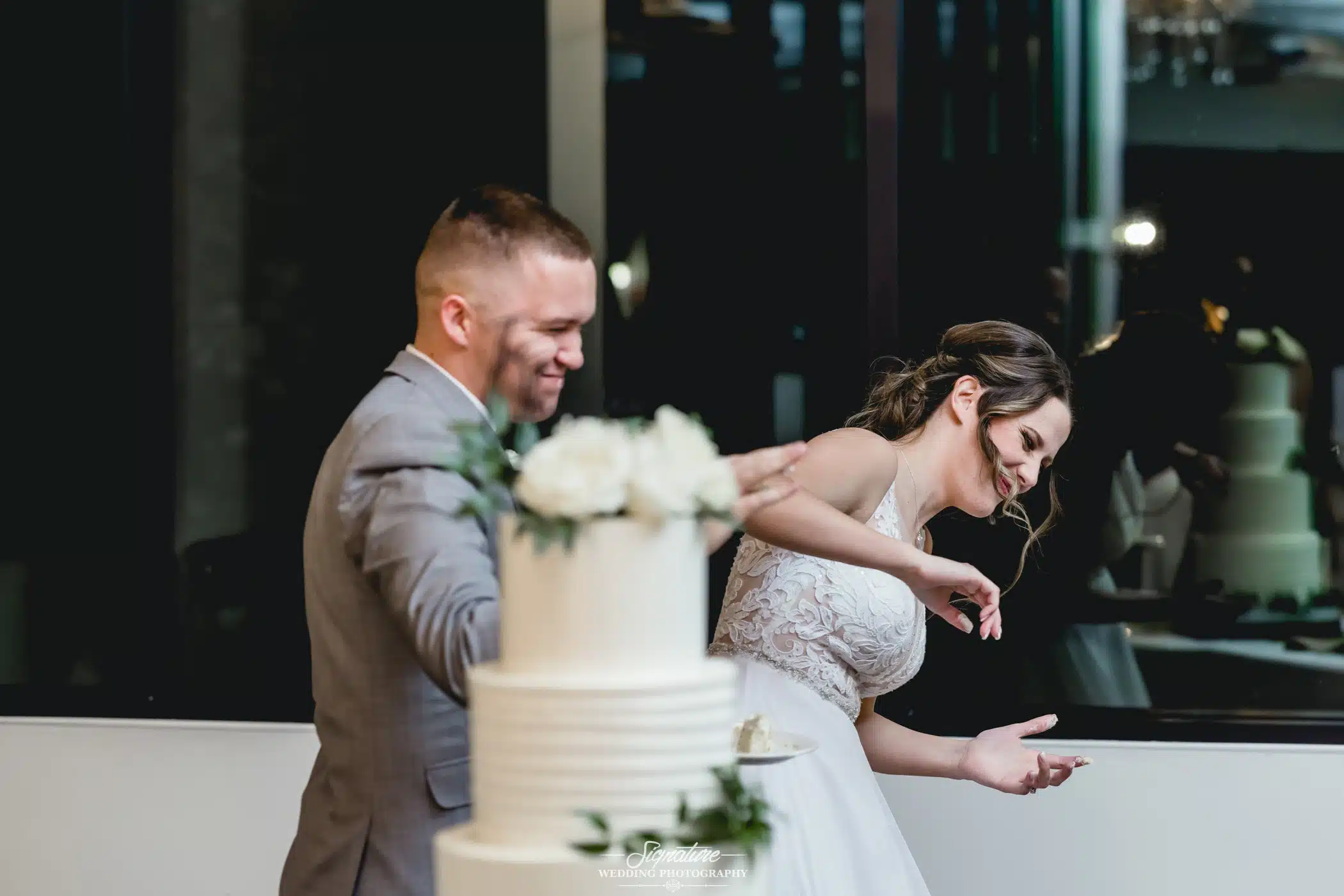 Image by Signature Wedding Photography Bride and groom cutting cake