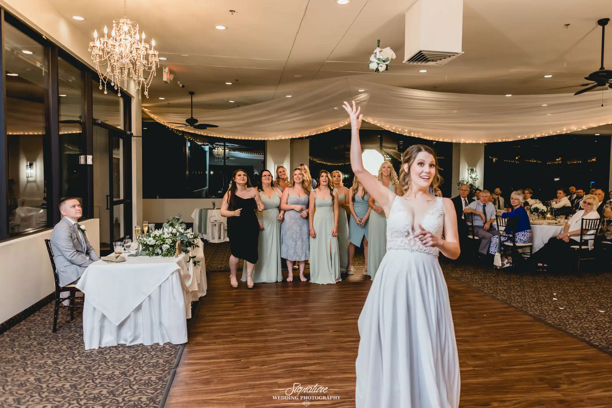 Image by Signature Wedding Photography Bride about to do the bouquet toss