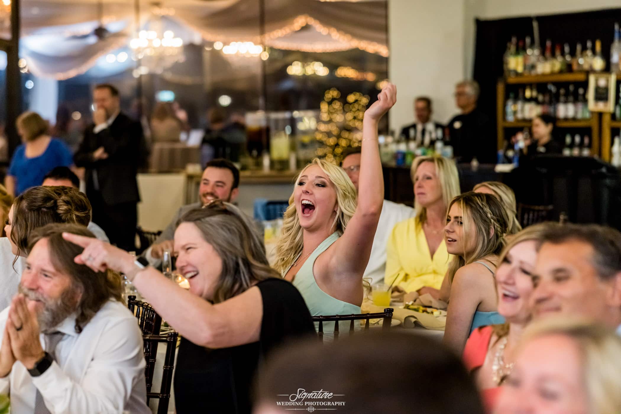 Wedding guests laughing during reception