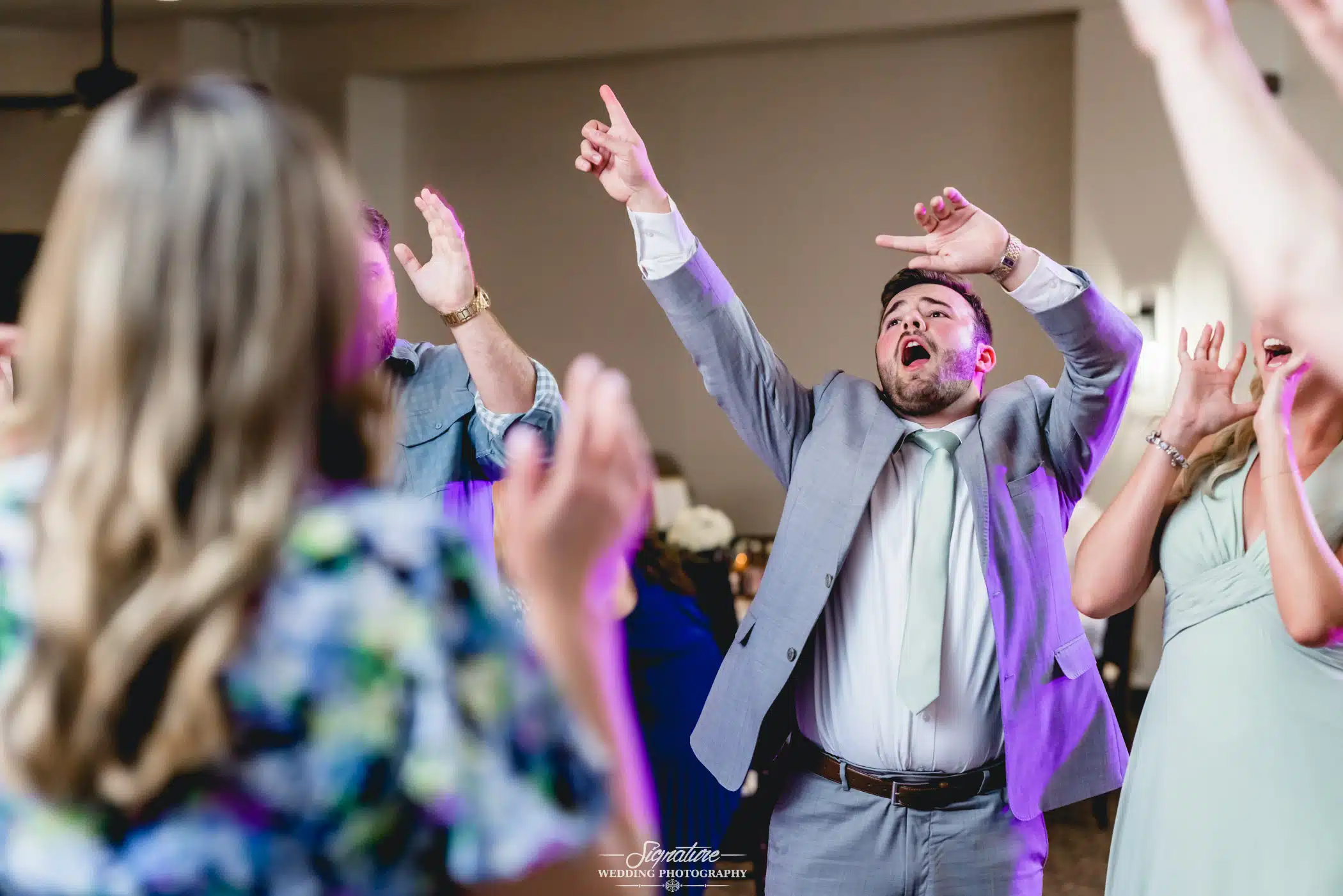 Image by Signature Wedding Photography Groom dancing with wedding guests