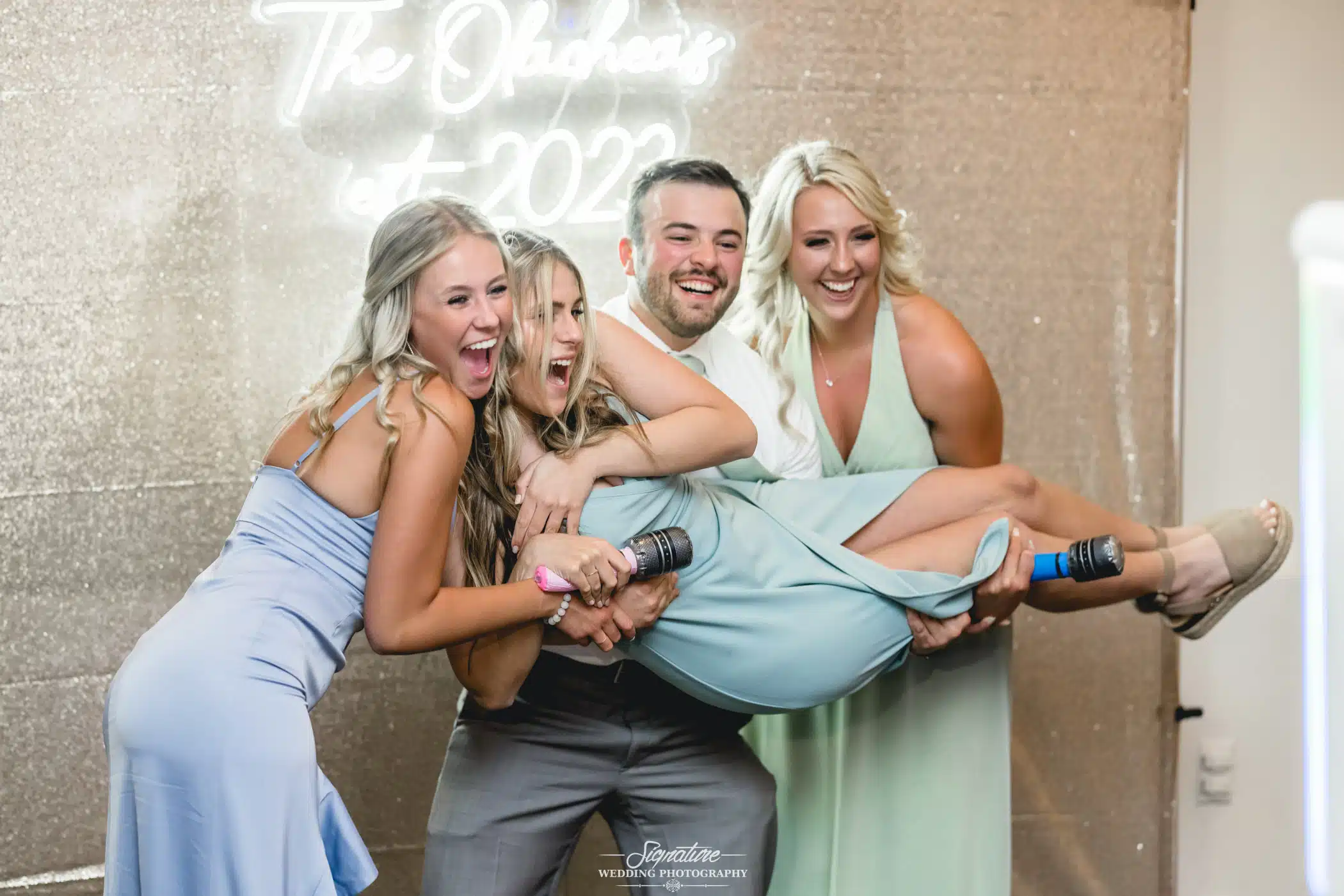Image by Signature Wedding Photography Wedding guests posing for photo booth
