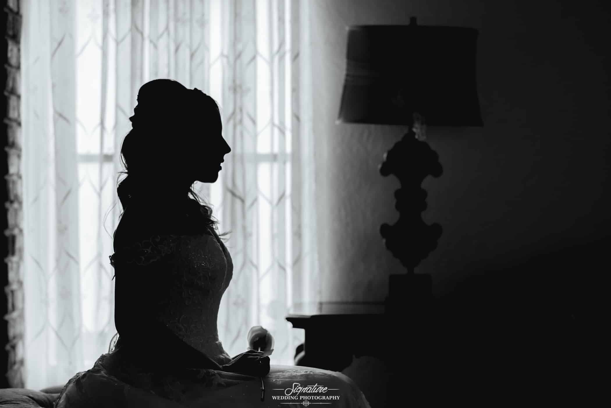 Bride sitting on bed silhouette